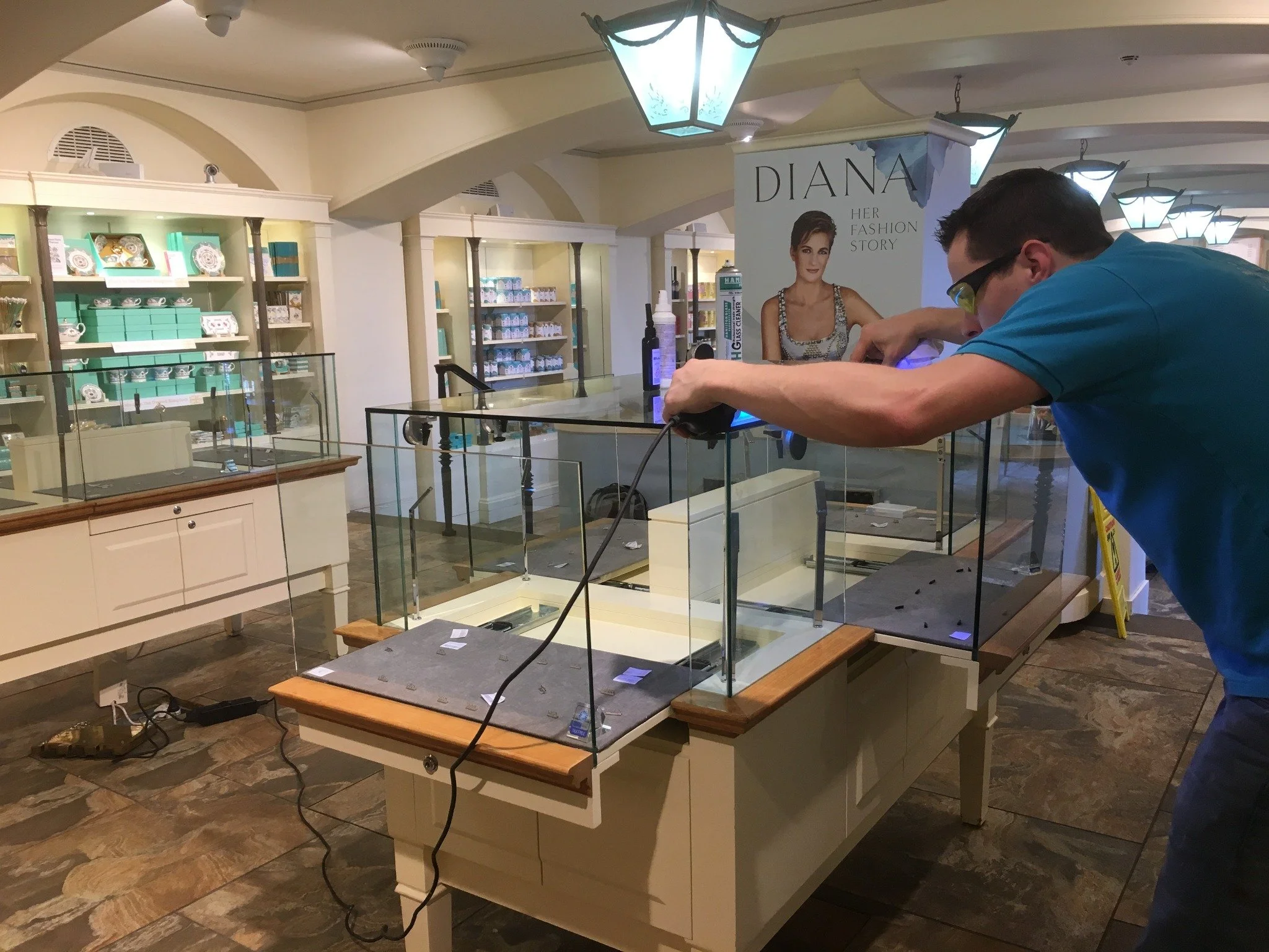 UV bonding process being carried out on glass display cabinets during the Diana exhibition installation at Kensington Palace
