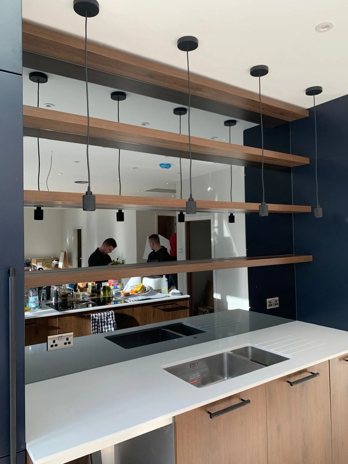 Bronze tinted mirror panels installed on a feature wall adding warmth and depth to a modern living space.