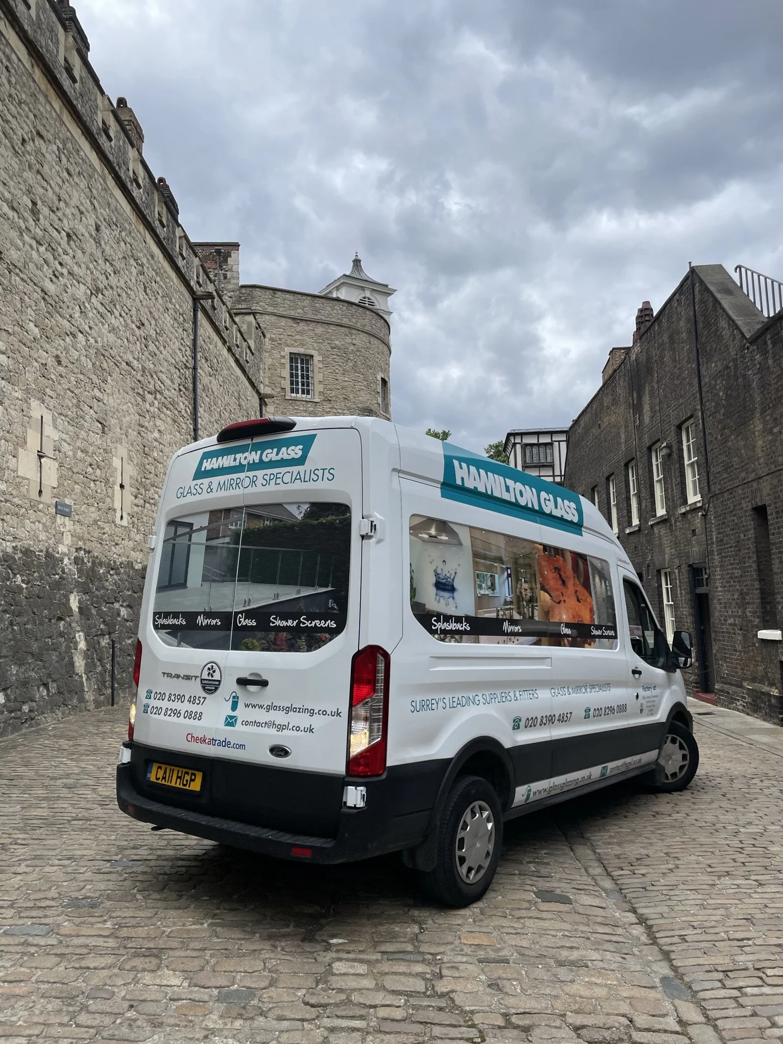 Hamilton Glass Products branded van parked on a cobbled street, showcasing local glass and mirror services across Surrey and South West London.