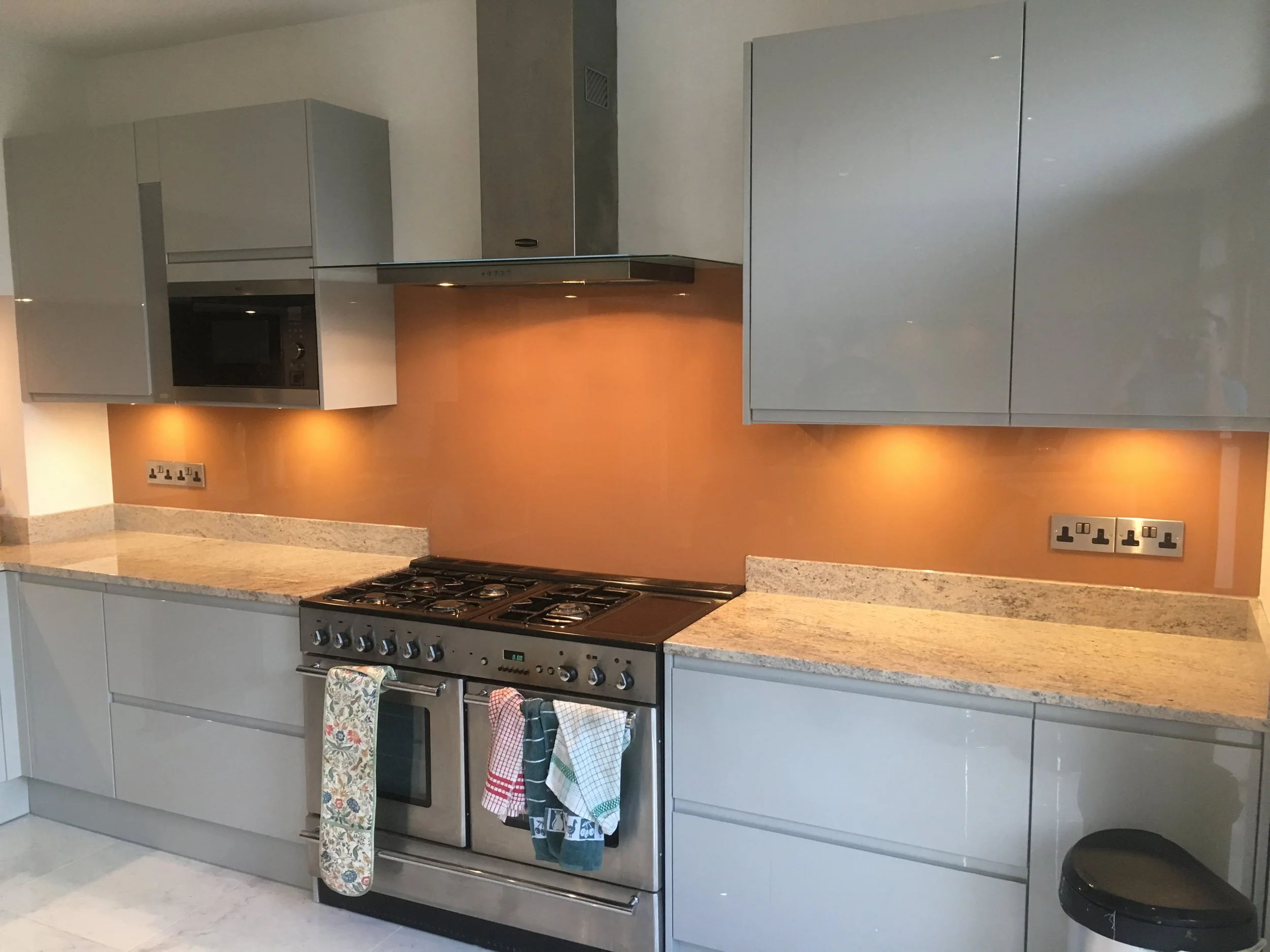 bronze coloured toughened glass splashback kitchen.JPG