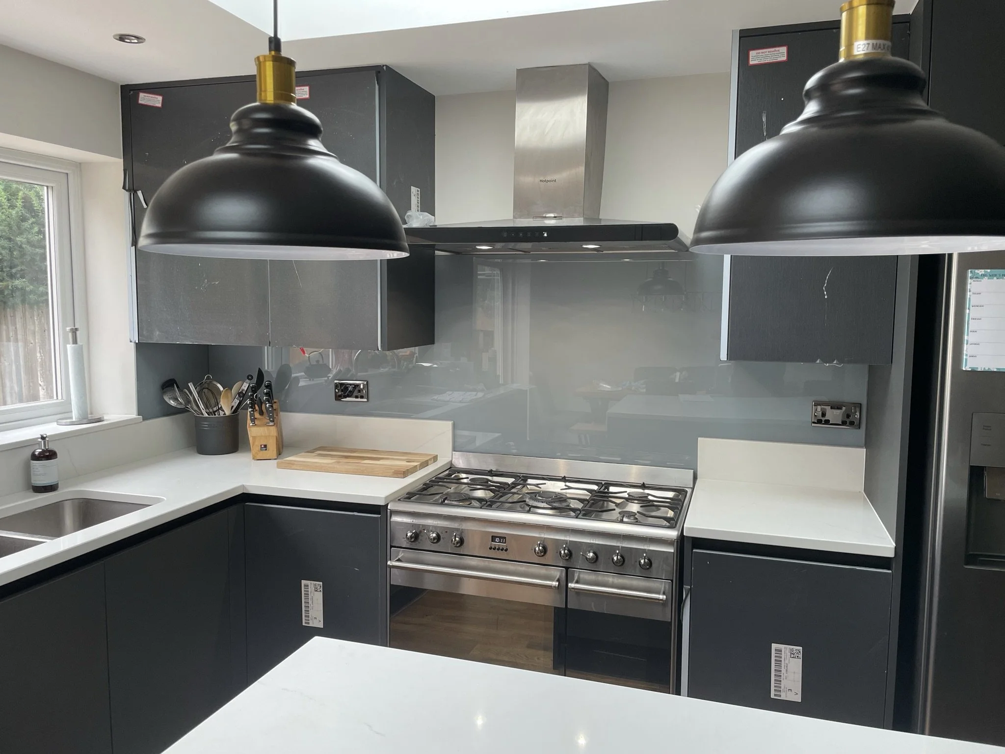 grey toughened glass splashback behind range cooker.JPEG