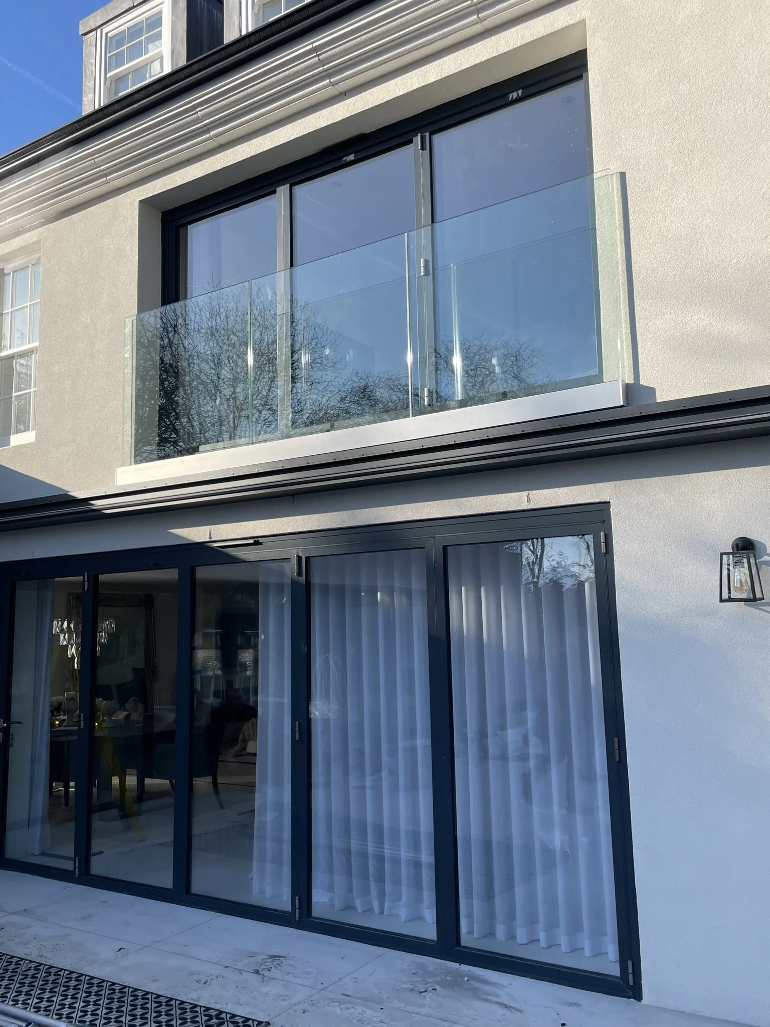 Toughened laminated glass Juliet balcony panel base-fixed to structure providing secure edge protection