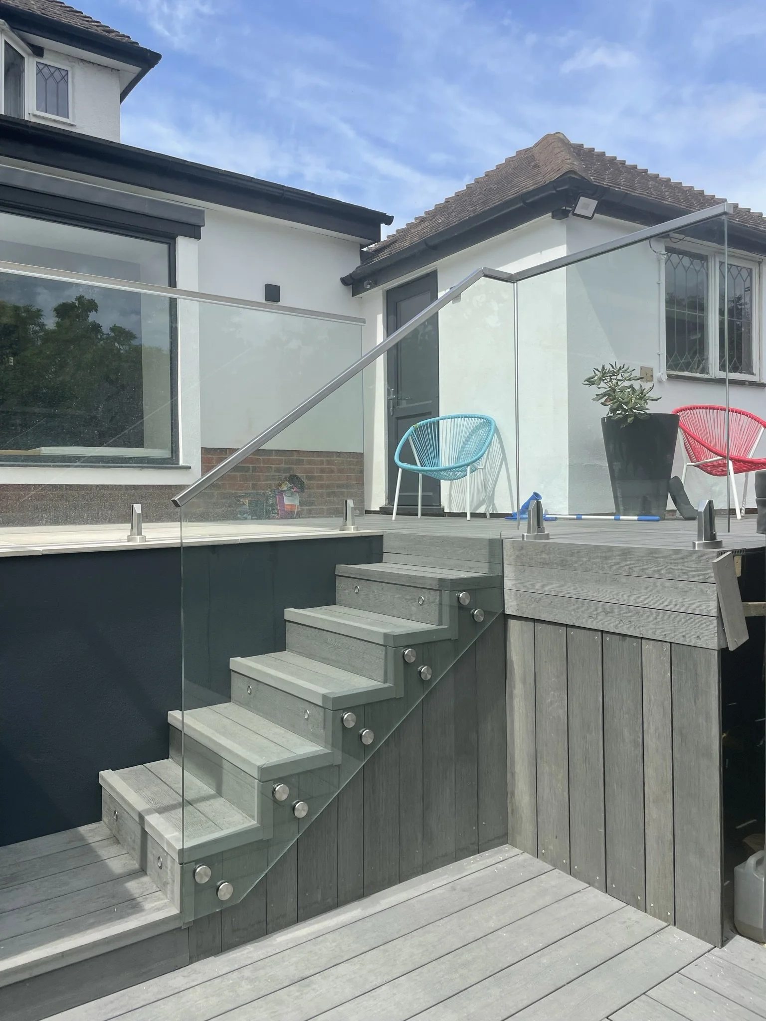 Toughened laminated glass balustrade panels face-fixed using stainless steel standoff fixings for structural edge protection