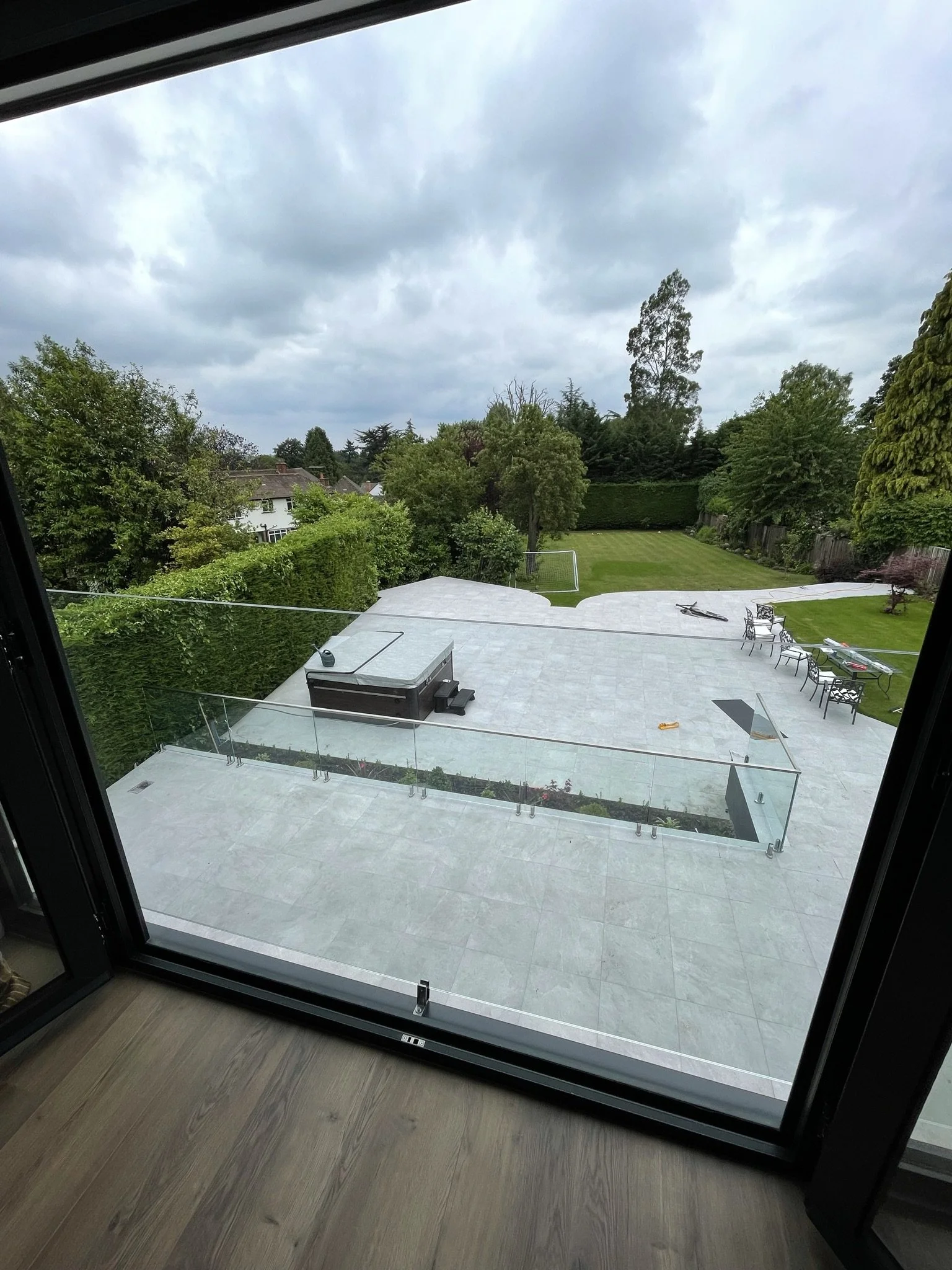 Frameless Juliet balcony using toughened laminated glass panels to maintain uninterrupted views with compliant edge protection