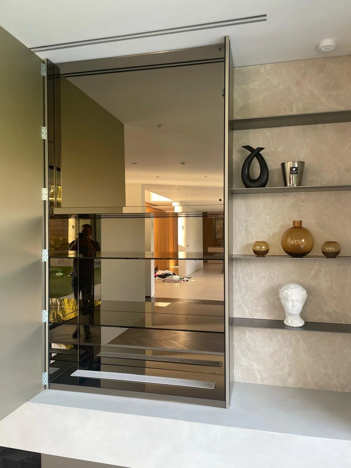 Frameless bronze tinted glass internal door and decorative glass screen installed in a modern Surrey home. Custom toughened glass panels with polished edges fitted by Hamilton Glass Products.