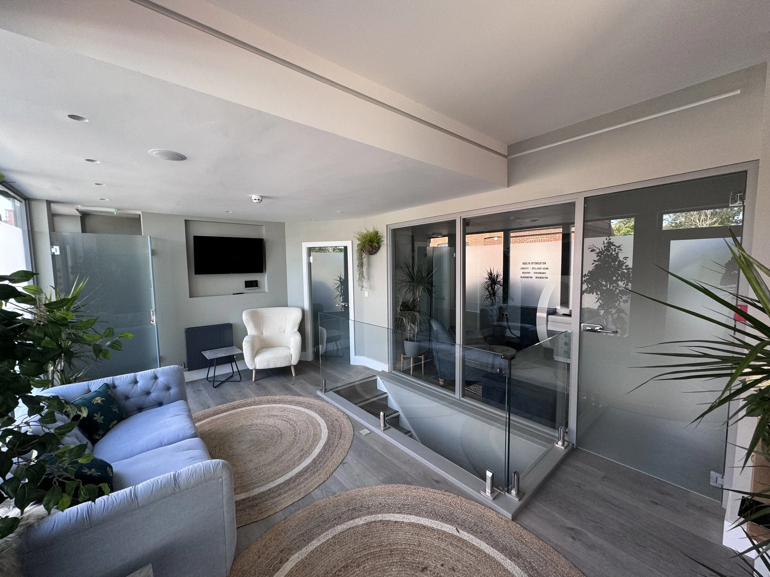 Glass partition system using toughened safety glass with frosted privacy treatment for enclosed rooms