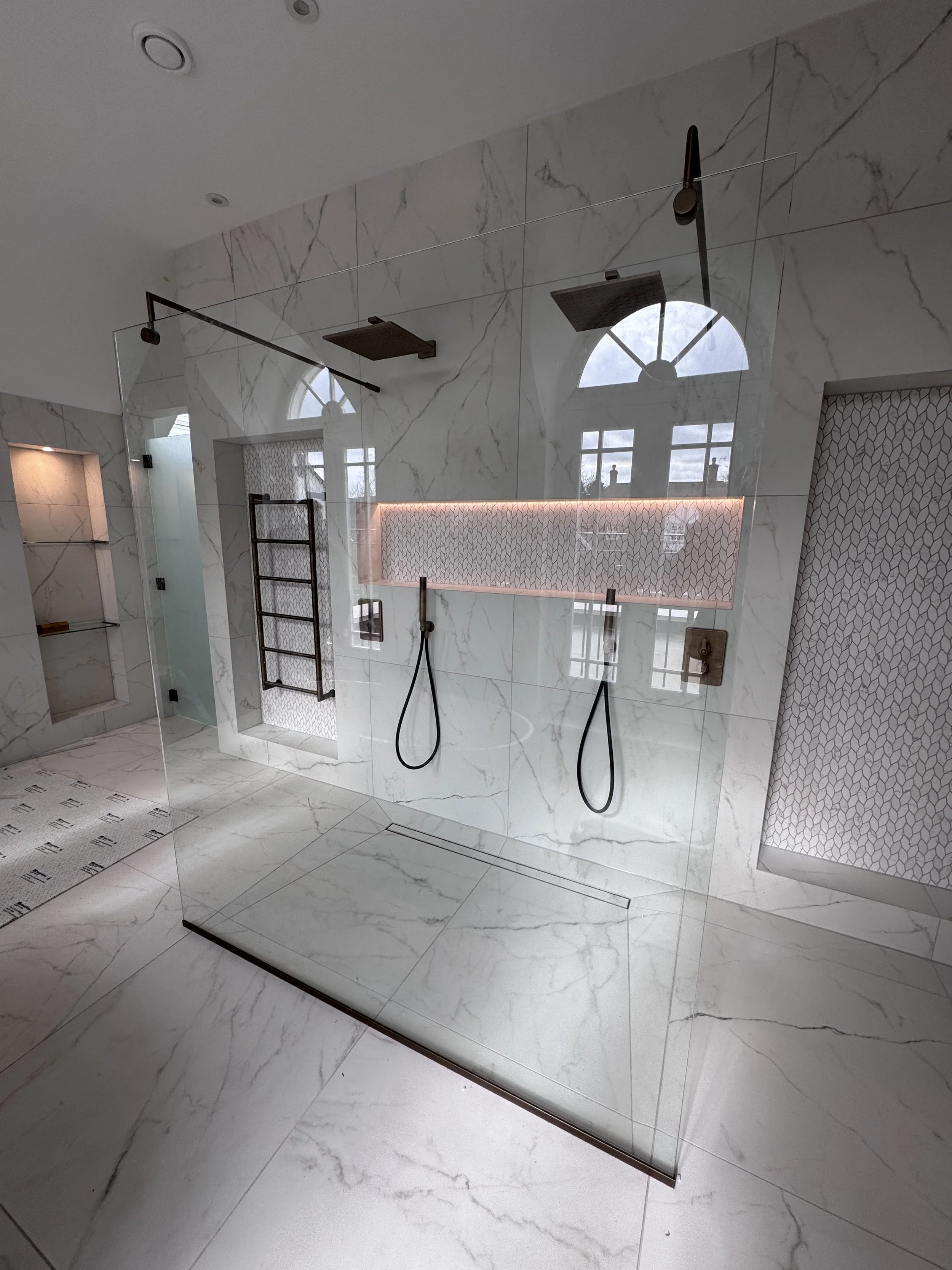 Freestanding walk-in shower in an amazing bathroom in St. George's Hill, showcasing modern design and luxury.