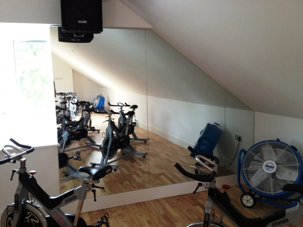 Professional dance studio mirror wall installation with safety backed mirrors fitted across an entire training studio.
