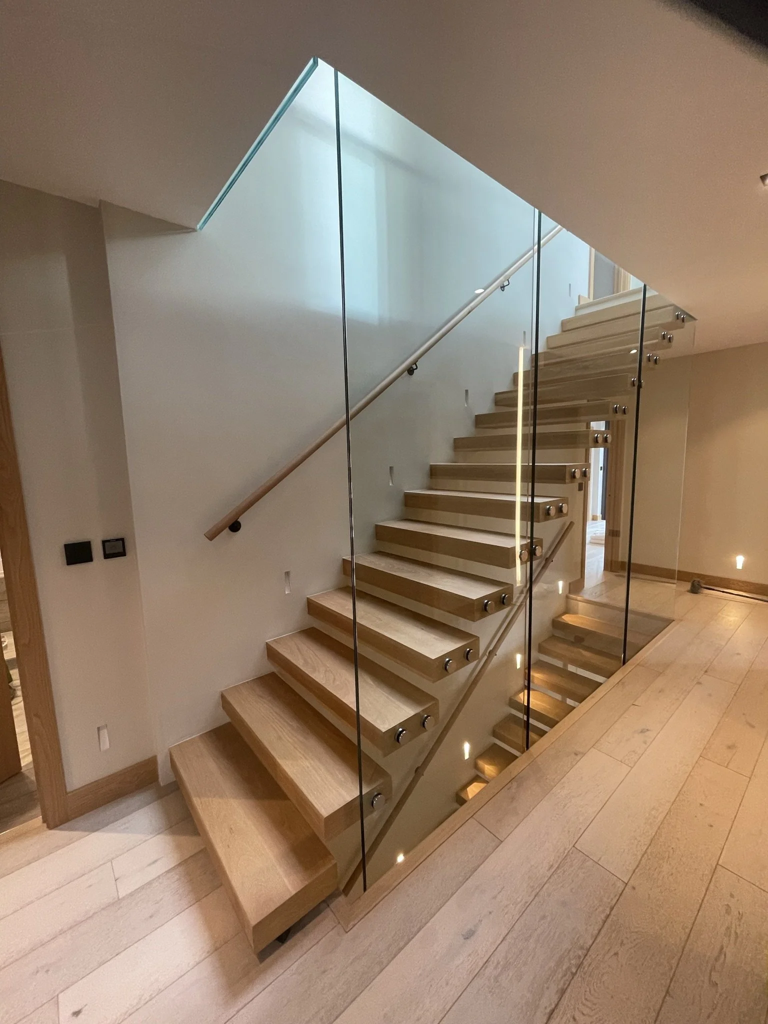 Structural toughened glass balustrade panels installed floor to floor providing frameless fall protection without posts
