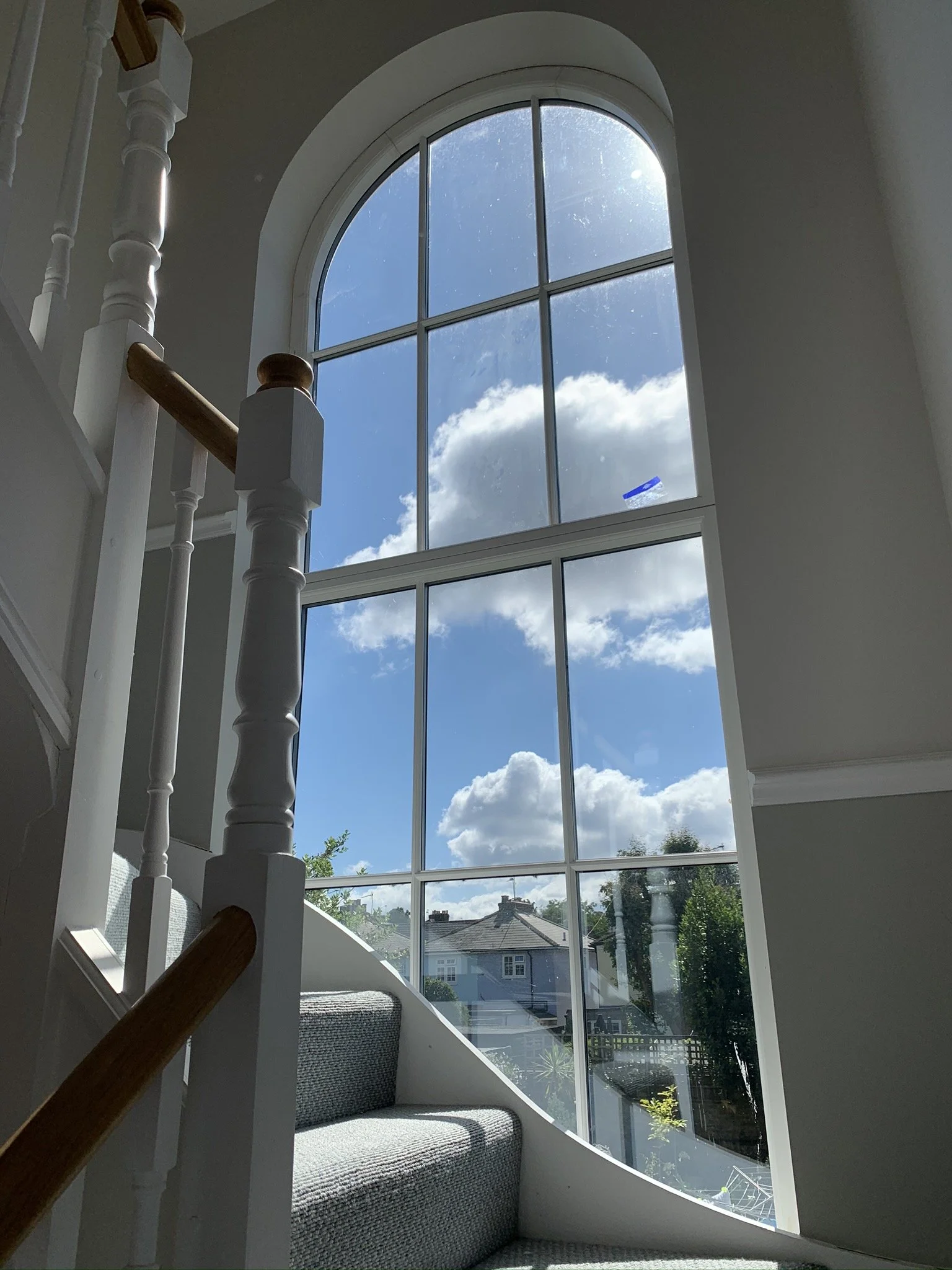 Sealed unit with a Georgian bar, installed in a staircase in Surbiton, featuring a duplex back-to-back spacer bar for enhanced design and stability.