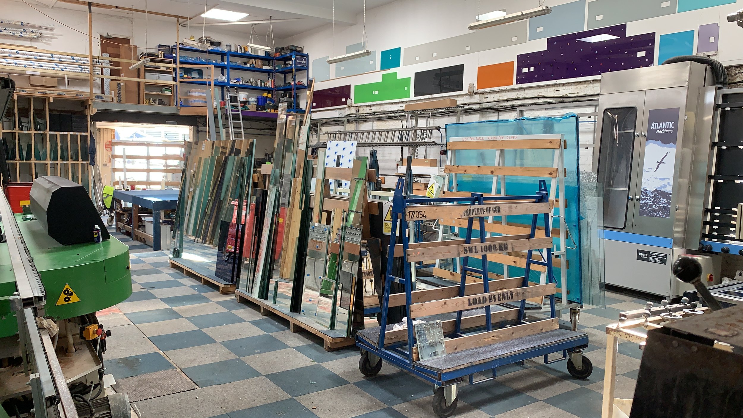 Professional glass processing facility with edge polishing, cutting and fabrication equipment