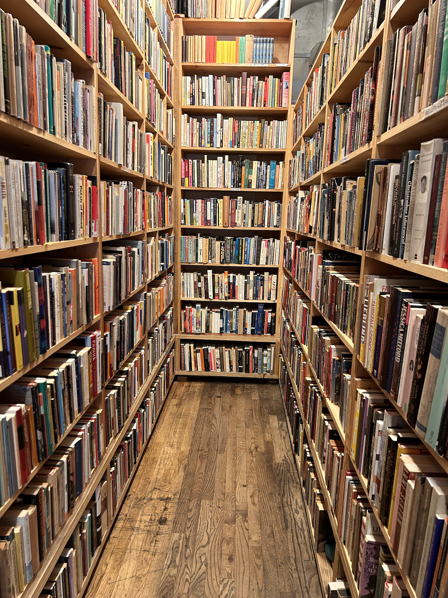 quiet library aisle filled with books, calm space to create mental space when your environment feels overwhelming