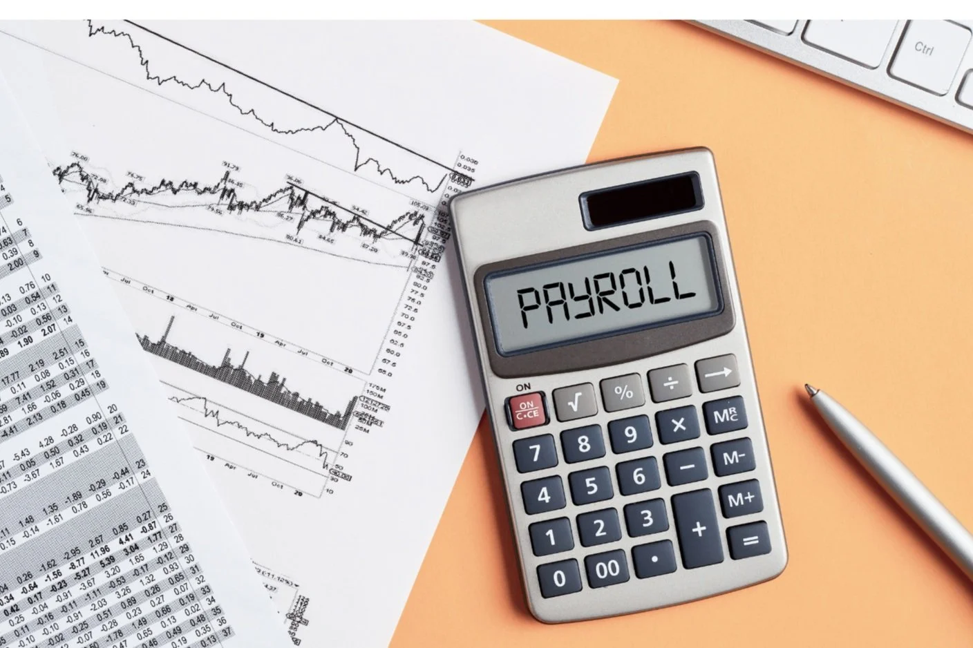 Calculator displaying the word 'PAYROLL' next to financial charts and a pen on an orange background.