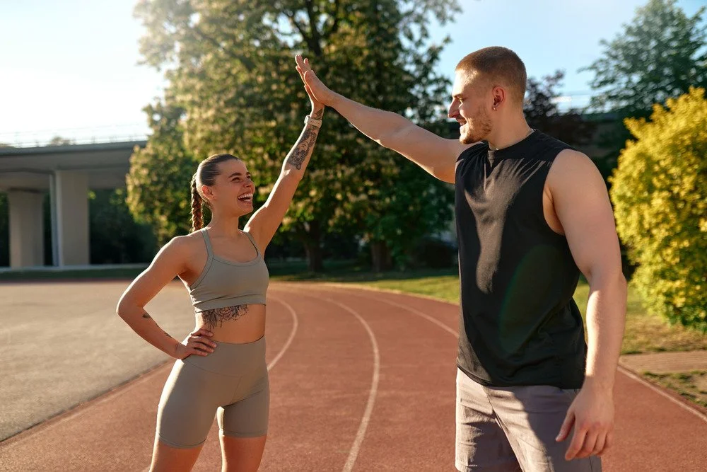 A couple on a running track.