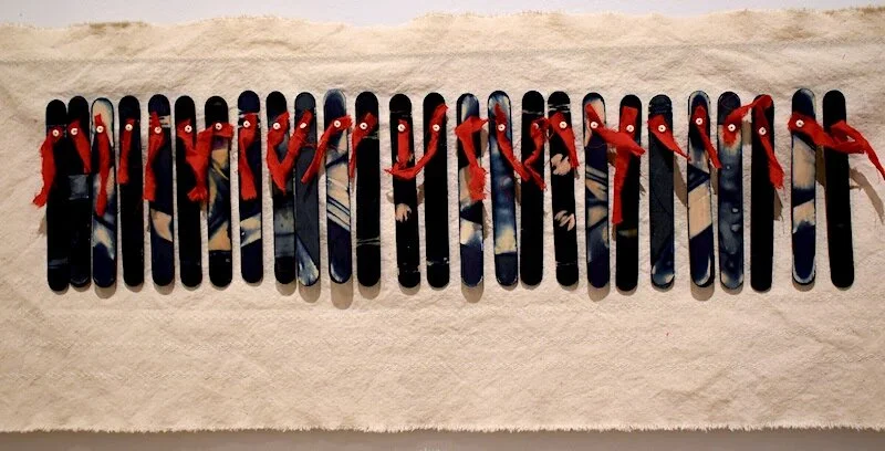 Ancestor Dance by Stephanie Lewis Robertson. Indigo, wood, embroidery floss, beads, cotton fabric, canvas. 12 1/2" x 33"