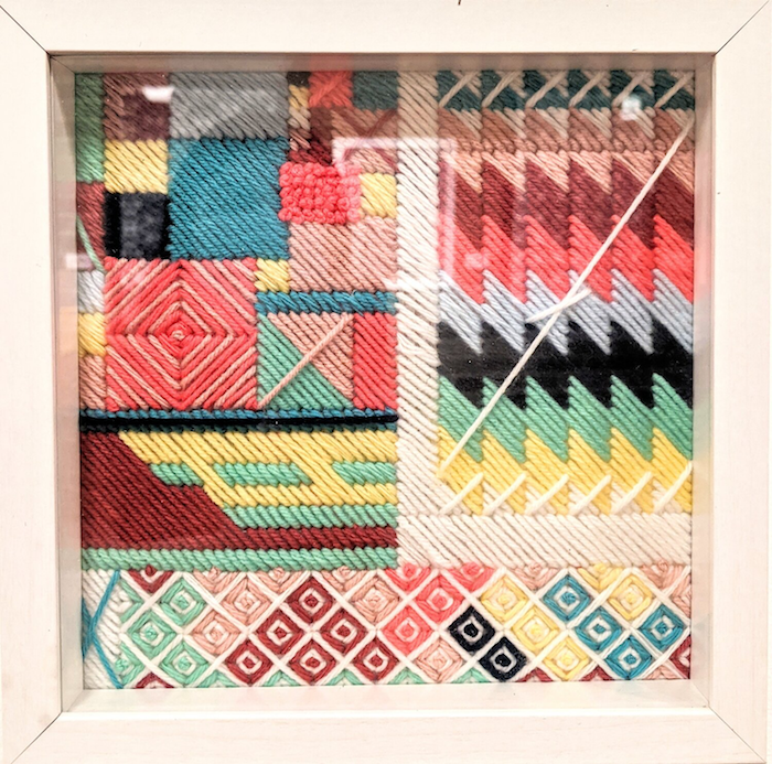 “In An Instant: Amalgamation (4)” Yarn on plastic canvas. Framed. 9” x 9.”