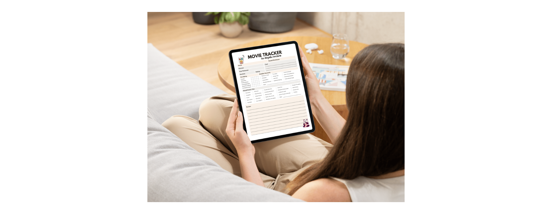 An image of a woman using the Now Playing movie trackers on her iPad while relaxing in her living room.