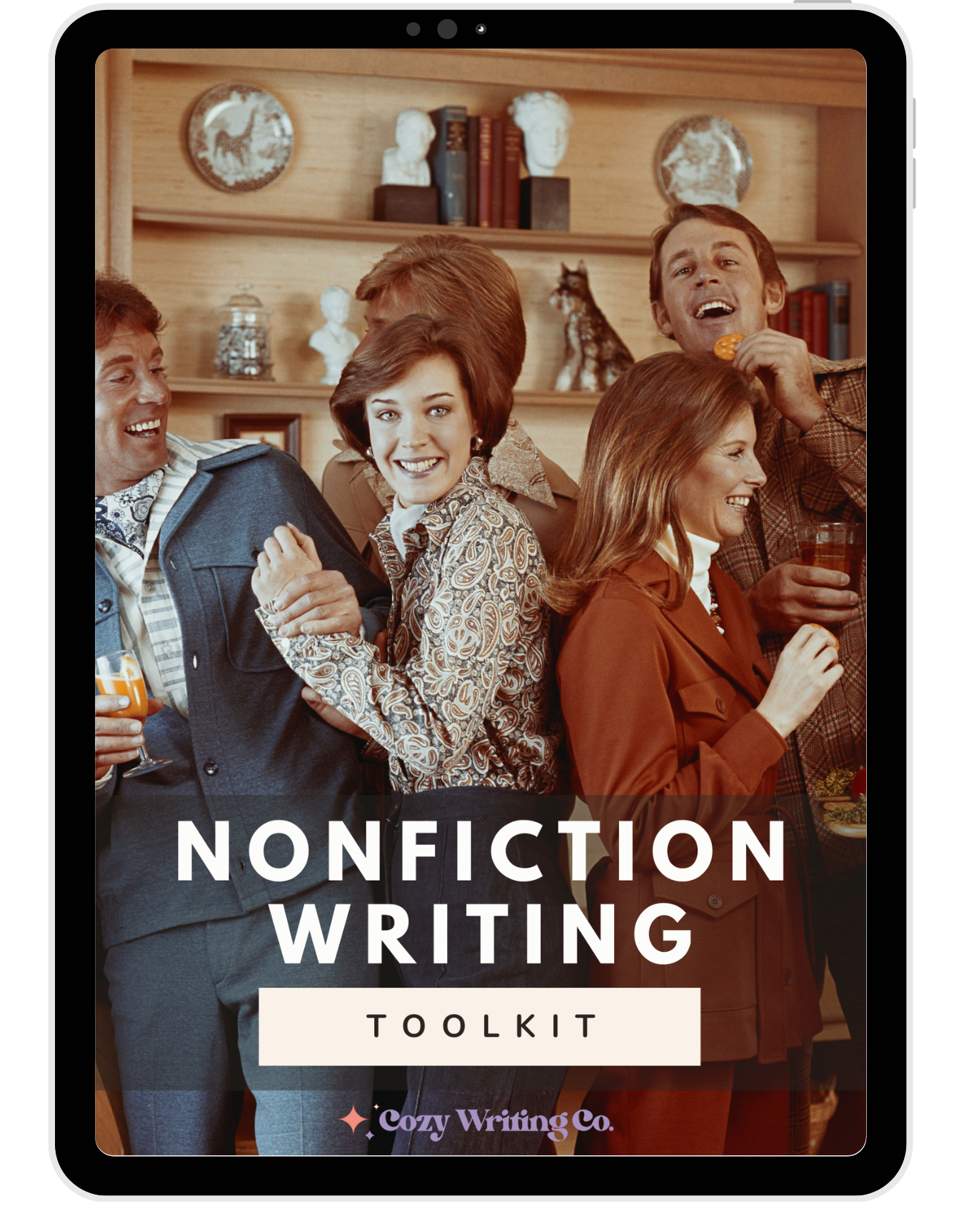 iPad with the Cozy Writing Co. Nonfiction Writing Toolkit cover showing a group of people smiling and celebrating at a 1970s party.