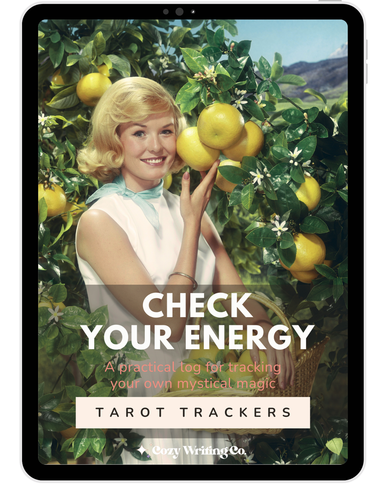 The cover of Check Your Energy tarot trackers, featuring a smiling woman picking yellow citrus fruits from an orange tree with white flowers in an orchard, holding a basket of fruit.