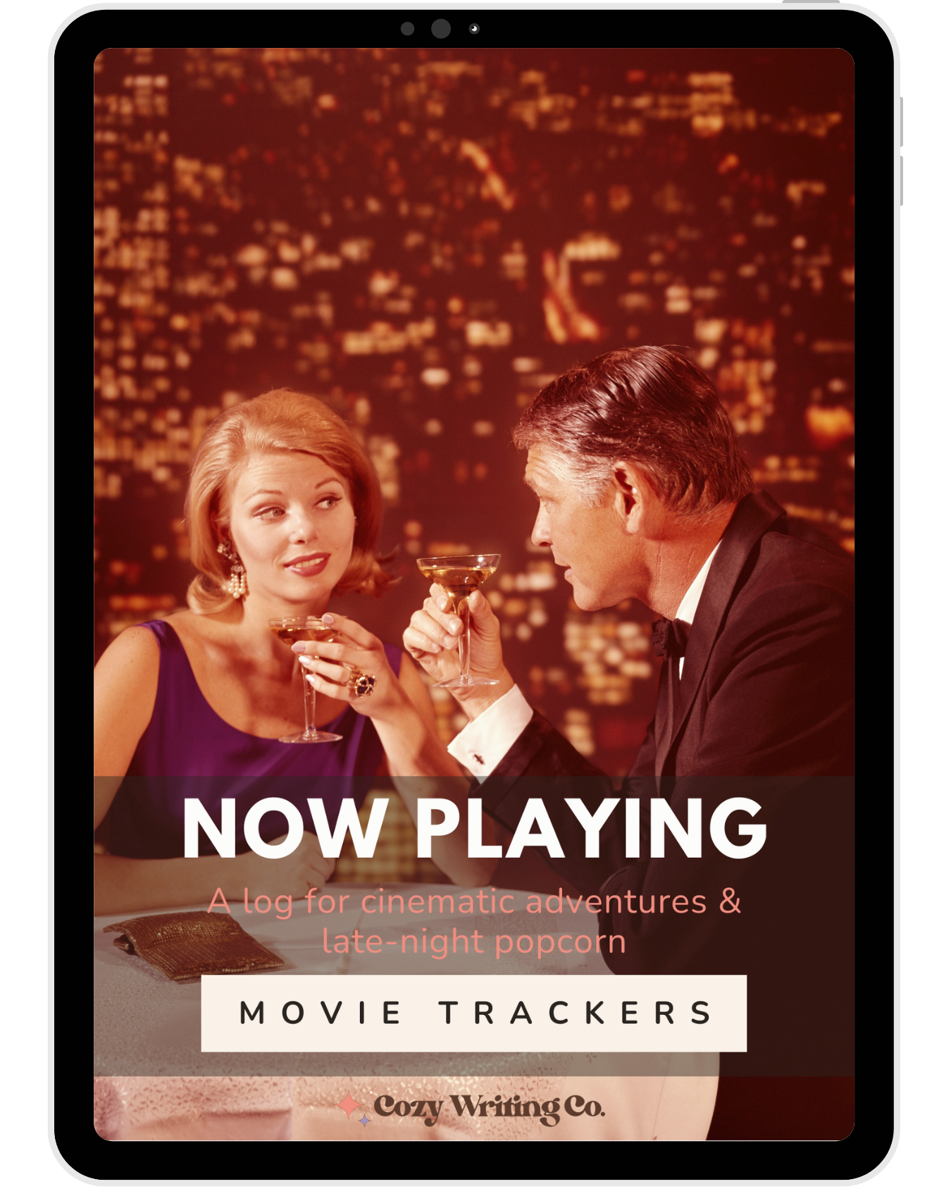 An image of a retro couple sharing drinks over dinner in a very cinematic fashion, showcasing the cover of the "Now Playing" movie trackers by Cozy Writing Co.