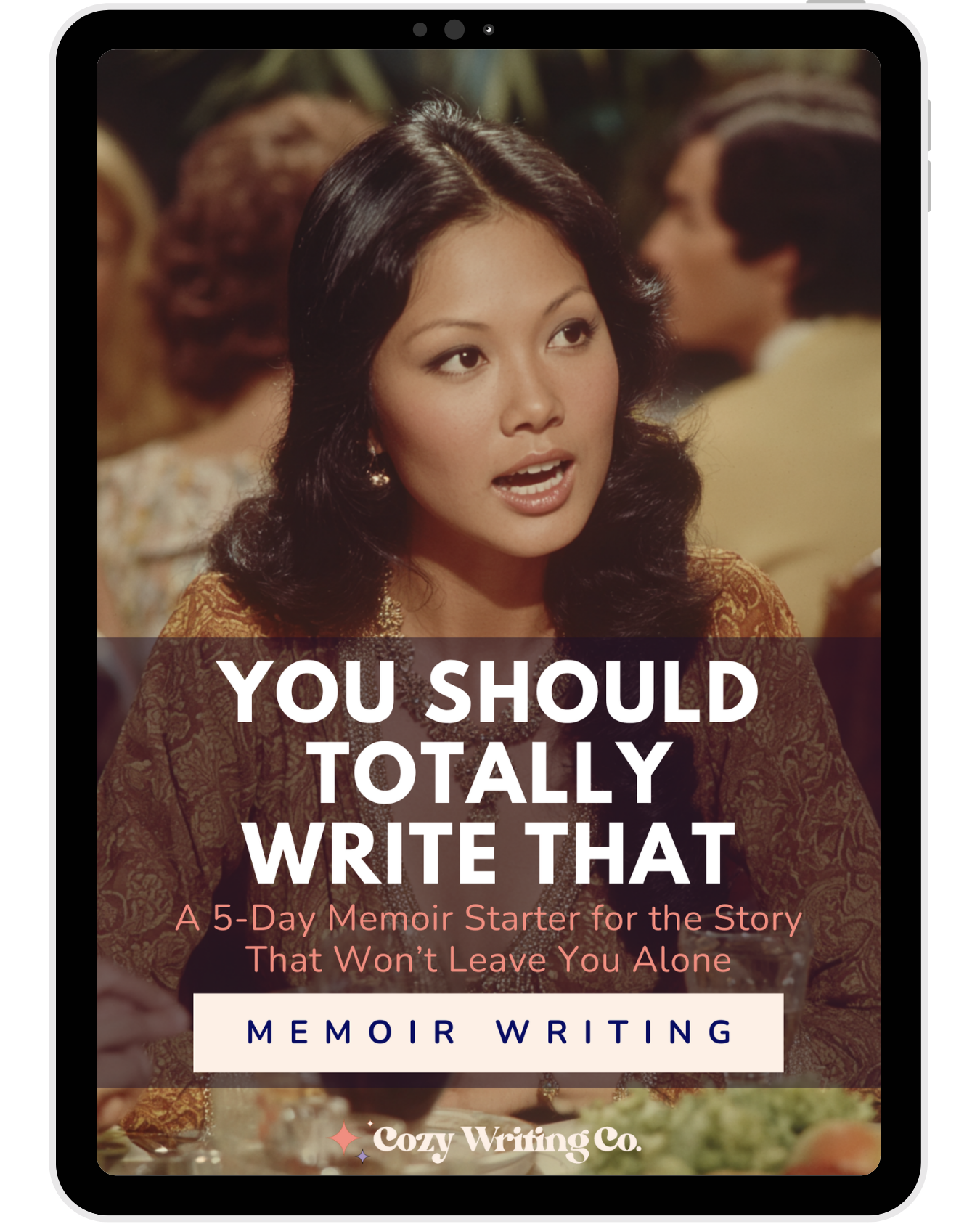 A woman animatedly speaking at a dinner party, on the cover of You Should Totally Write That - a five-day memoir starter for writers by Cozy Writing Co.