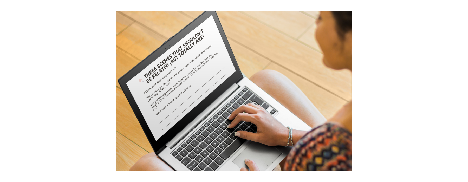 Person typing on a laptop while working on a memoir using guided writing prompts.