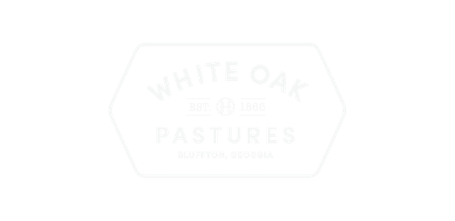 Logo for White Oak Pastures with an octagonal border and text indicating the farm's name and location in Bluffton, Georgia.