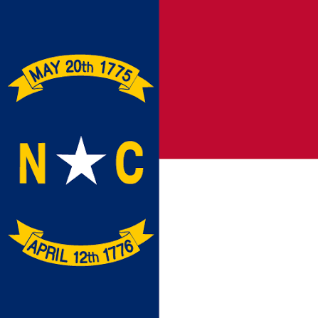 North Carolina state flag with blue vertical band on the left, featuring dates 'May 20th, 1775' and 'April 12th, 1776' on yellow banners, the letters 'N C' and a white star in the center, and red and white horizontal stripes on the right.