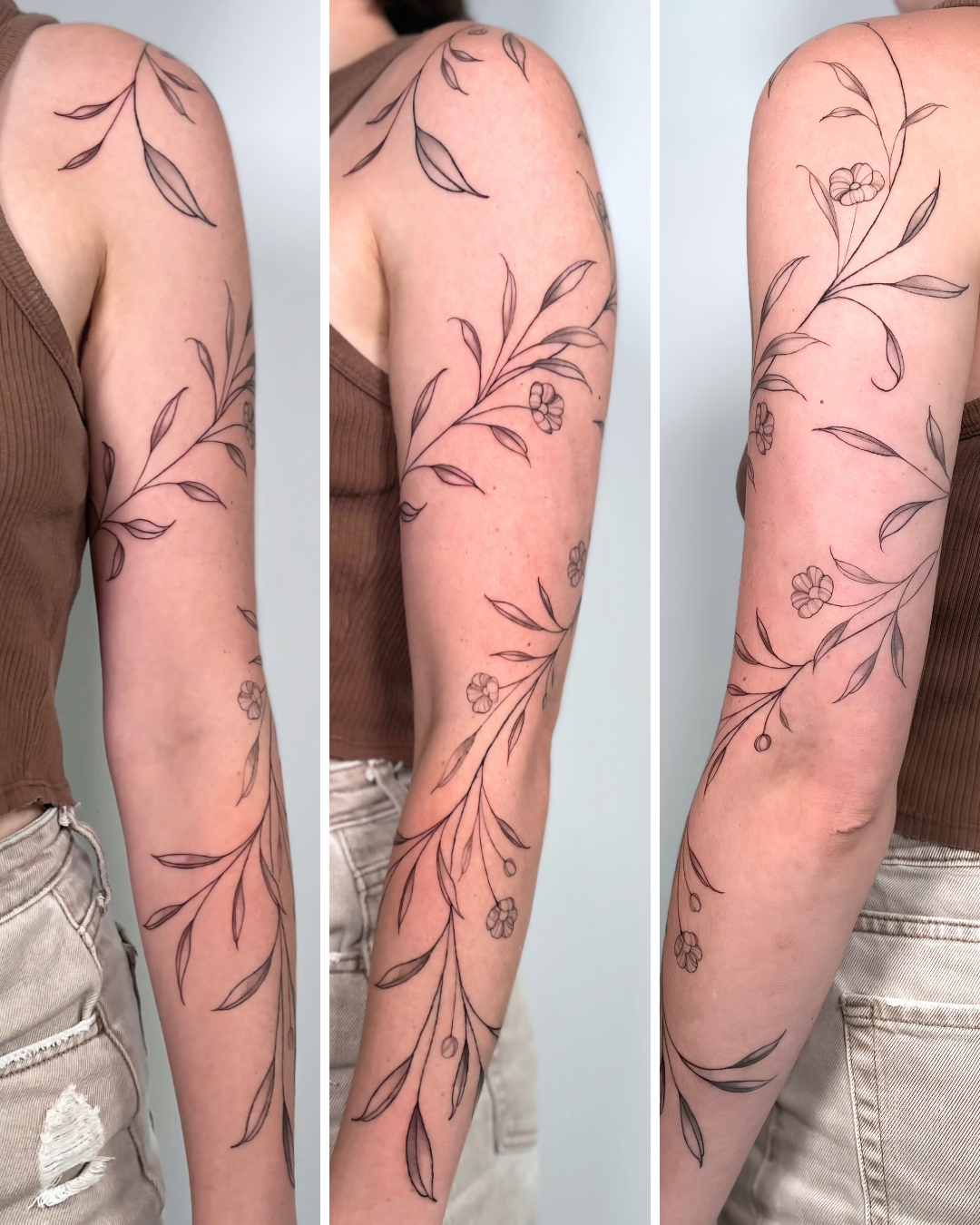 A woman with a floral tattoo extending from her shoulder down her arm, featuring delicate leaves and small flowers in black ink.