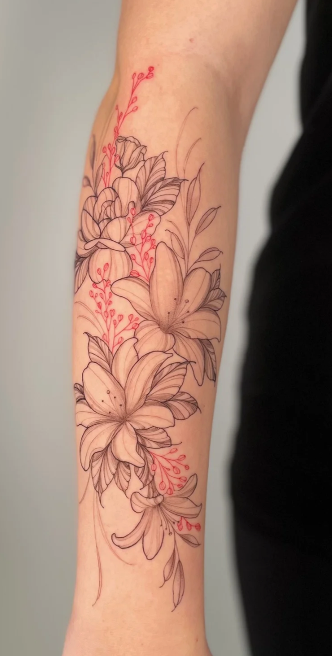 Black and gray floral tattoo on a person's forearm, with pink highlights on some small details.