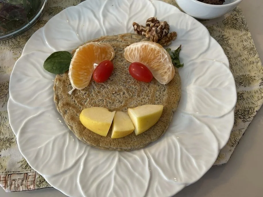 Pancake with fruit making a face