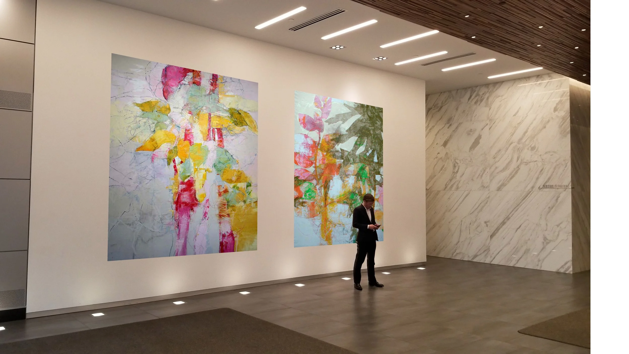 An art gallery with two large colorful abstract paintings on a white wall, a man in a suit looking at his phone, and a marble wall with a signature.