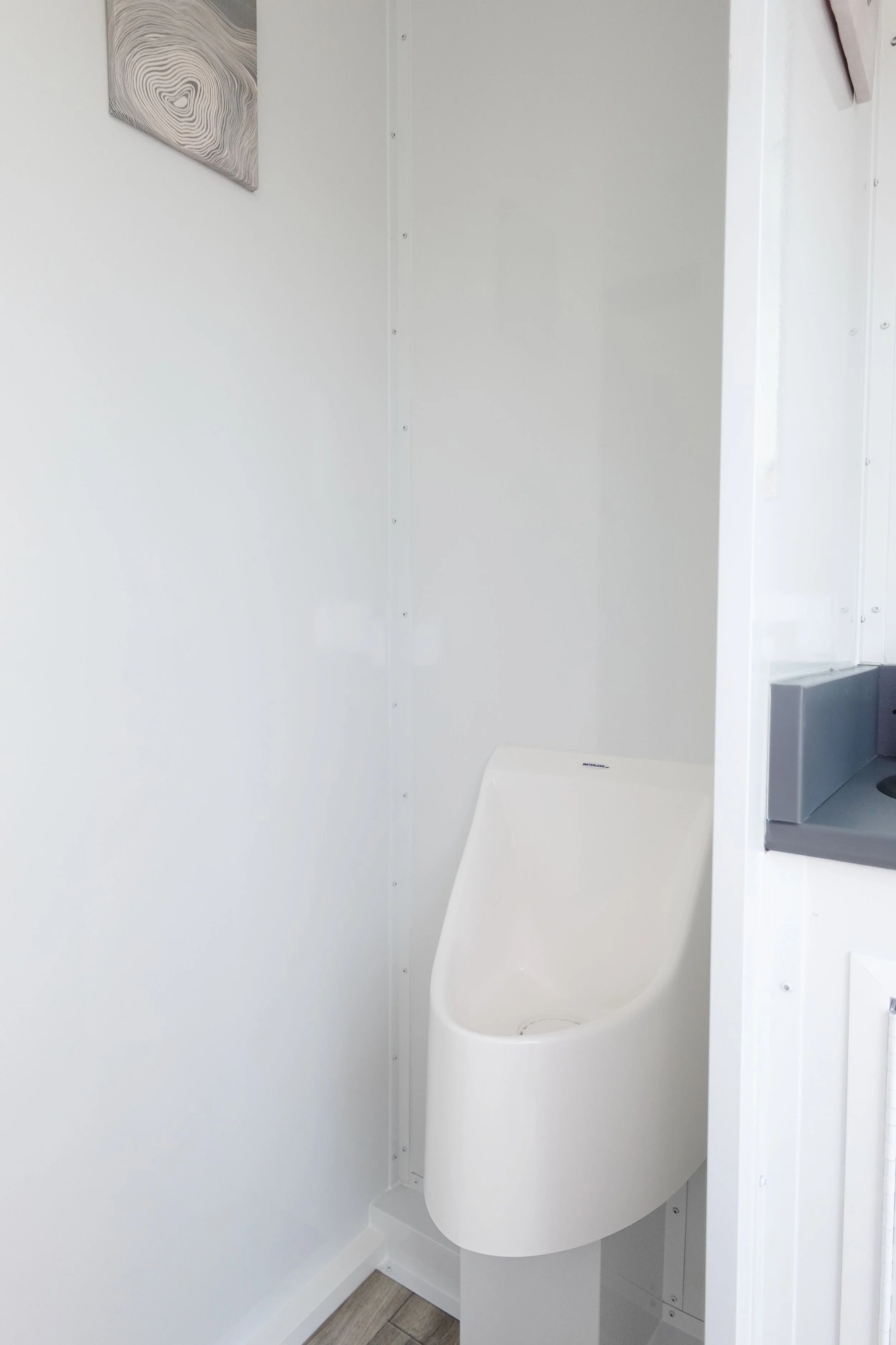 Women's restroom interior with private stalls and sink in a 4-stall luxury restroom trailer