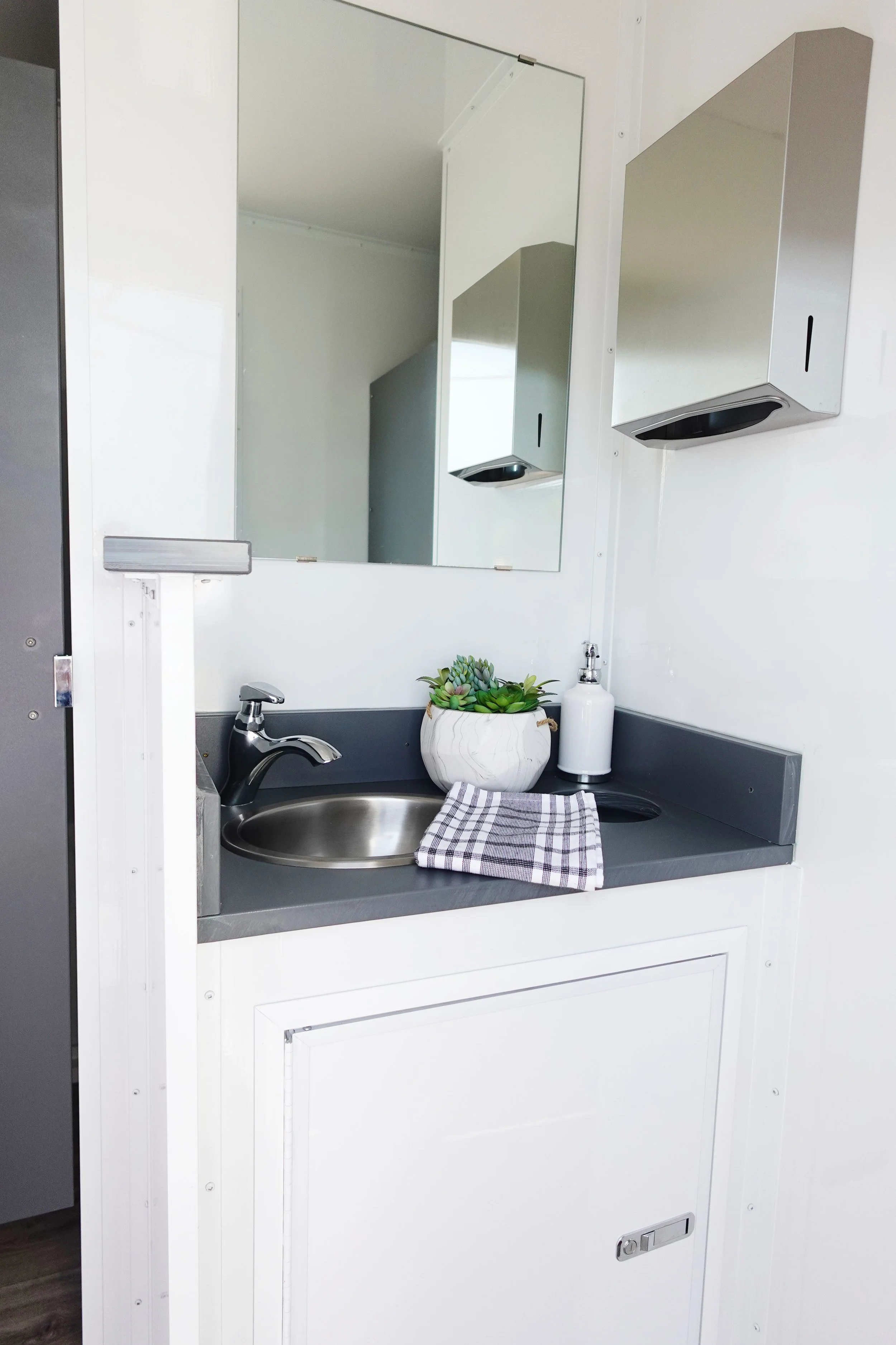 Interior of a 4-stall luxury restroom trailer available for rent in Nashville, TN