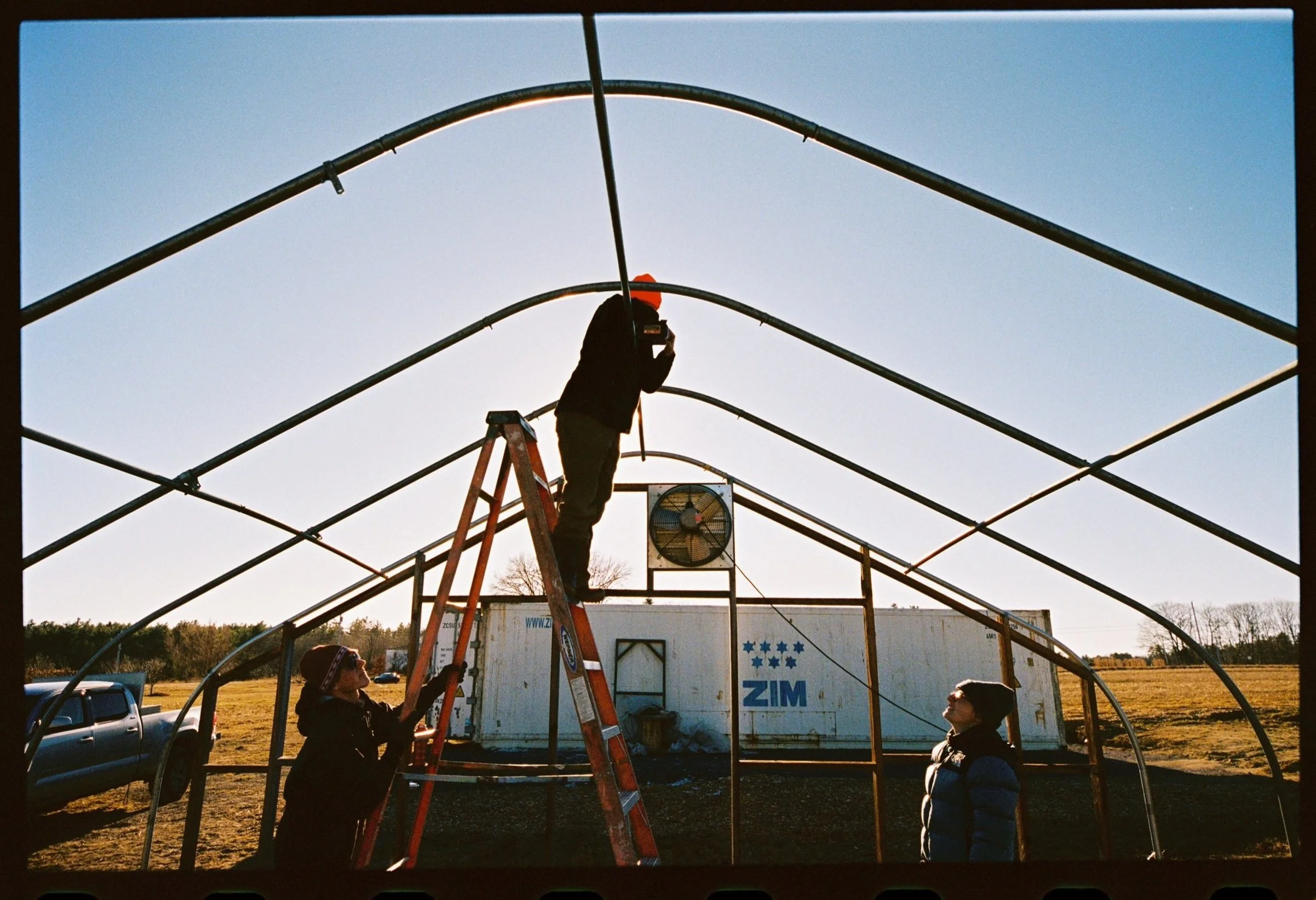 Oranssi technician working on a roof project