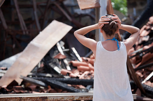 Image of woman in shock from house fire aftermath