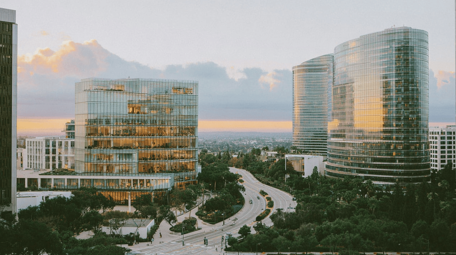 Aerial view of a modern tech campus at golden hour with interconnected glass buildings and glowing blue network lines, a winding road leading toward a bright horizon, representing growth and transition in the IT managed services industry
