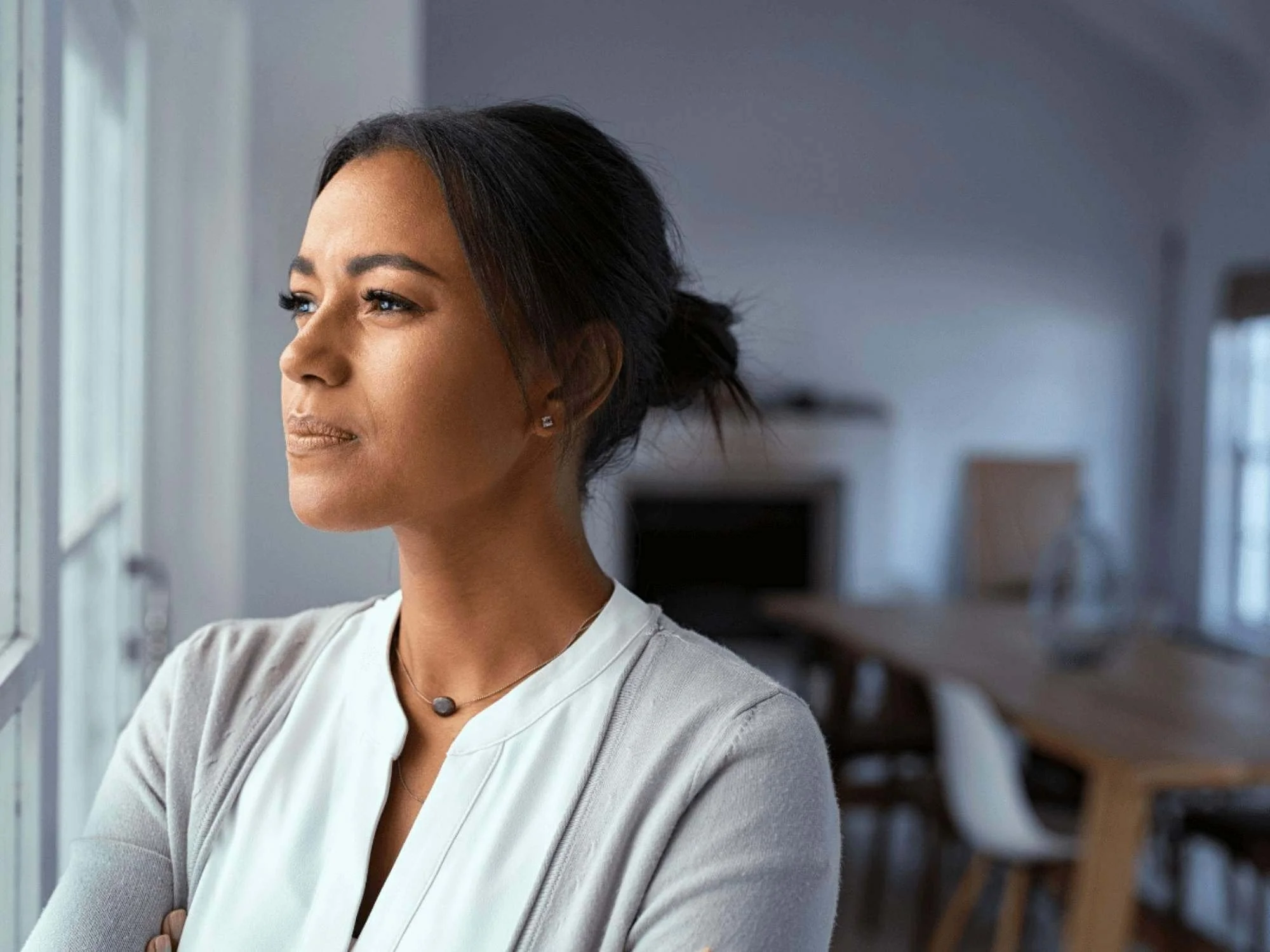 Woman looking out the window because of bipolar depression