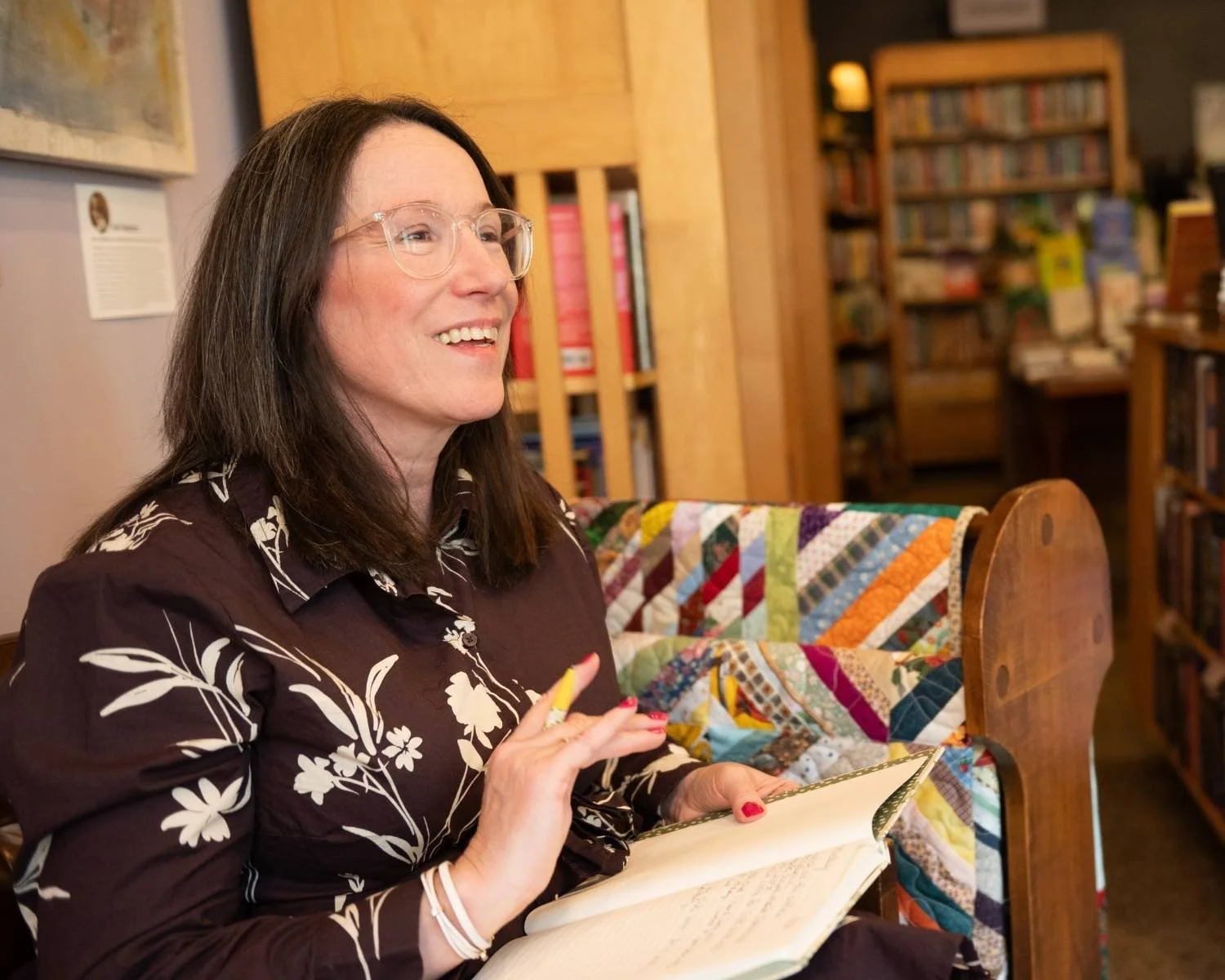 Emily Mendez writing in a notebook, founder of Thriving With Bipolar