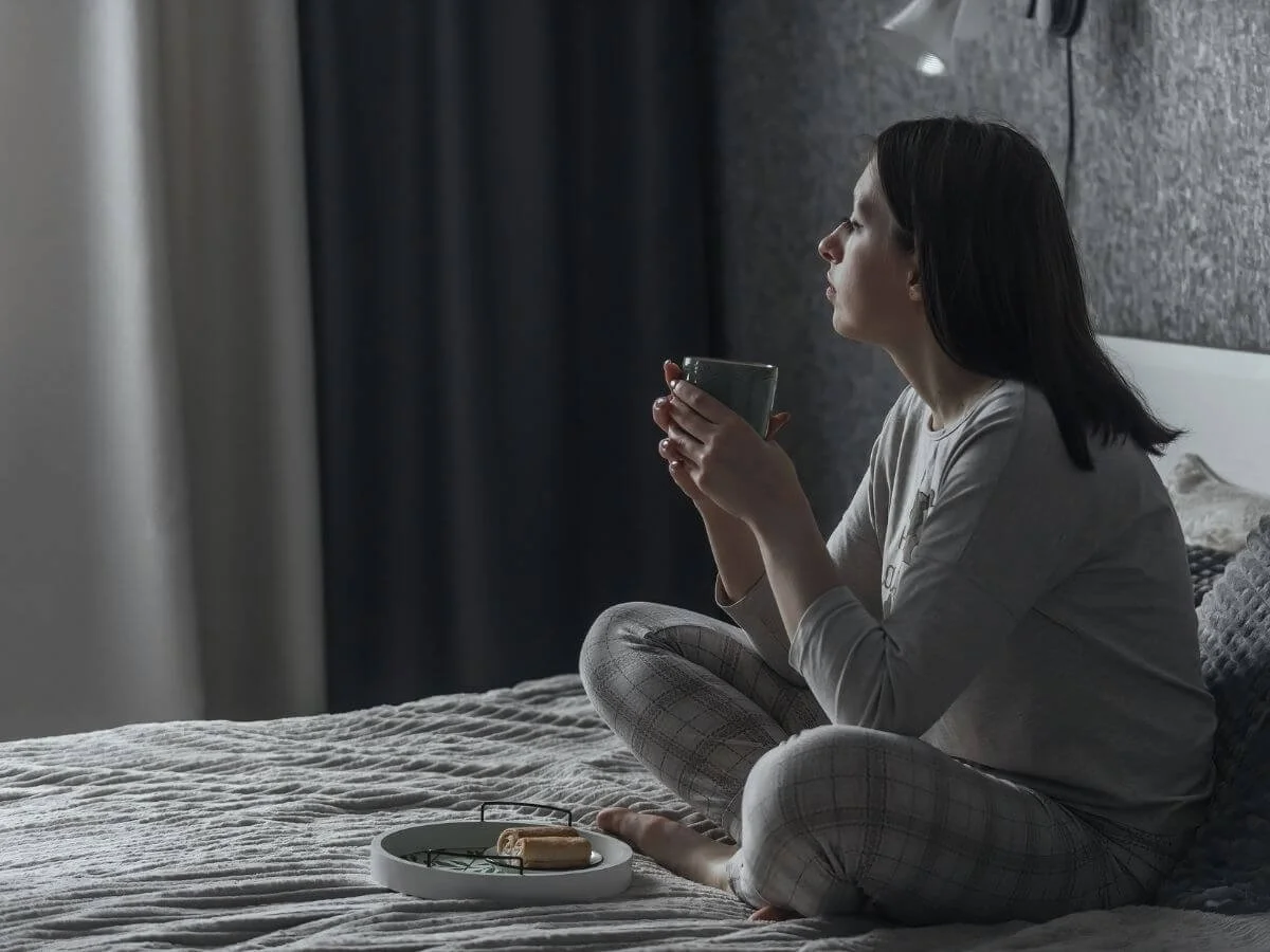 Women looking out the winter window symbolizing winter bipolar depression