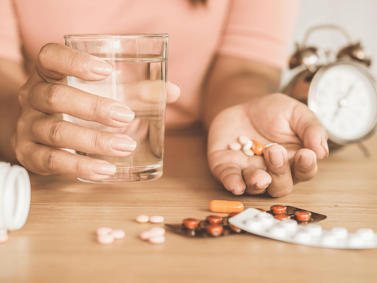 woman holding mood stabilizers for bipolar 2 in her hand.