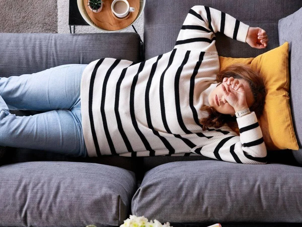 Girl laying on coach showing how jet lag affects bipolar.