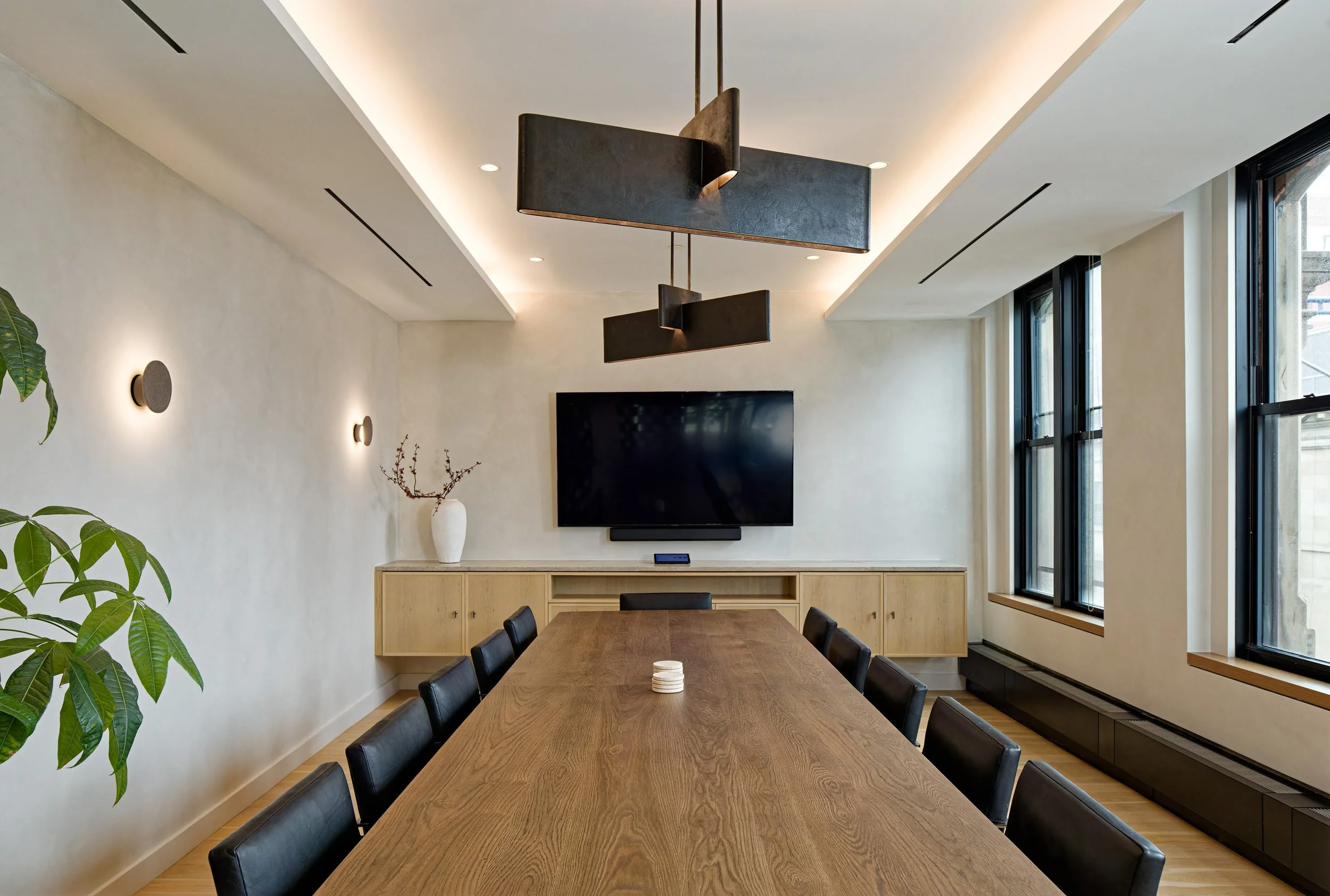 Long conference room with white oak wood cabinetry and Kelly Wearstler pendants, Soho office creative direction