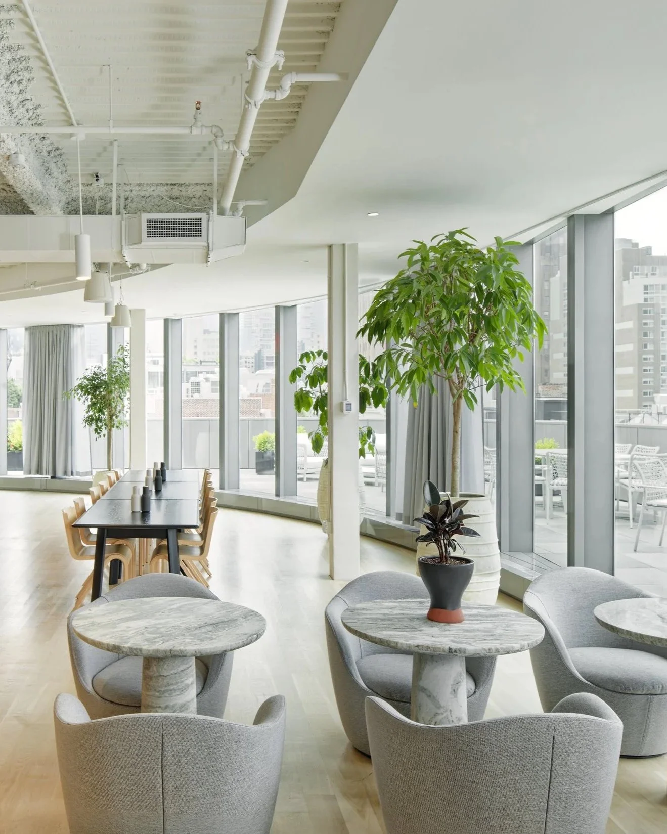 Bright open workspace with lounge seating, programmatic spatial design, Soho office interior