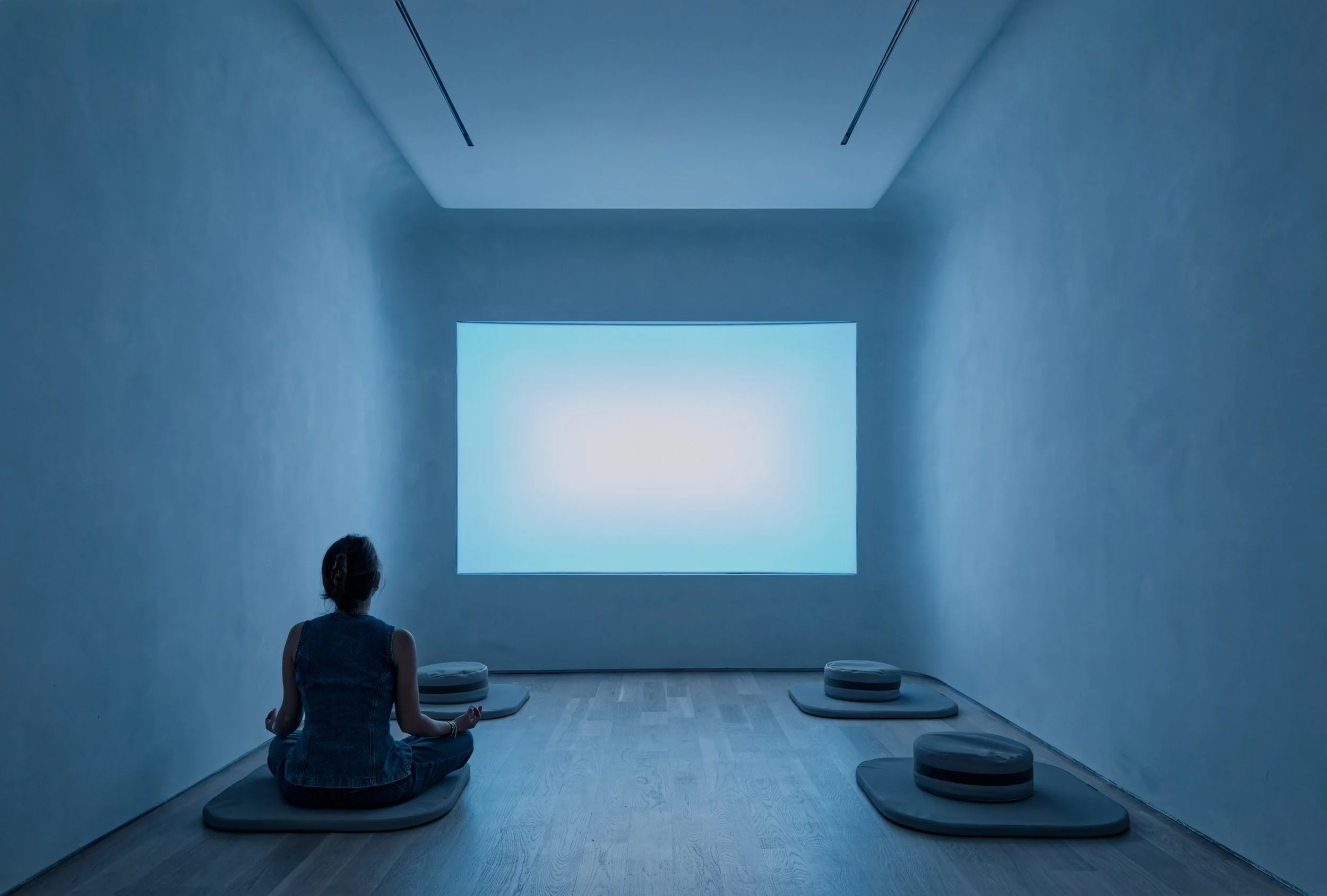 James Turrell-inspired color-shifting light wall in meditation room, experiential office interior design
