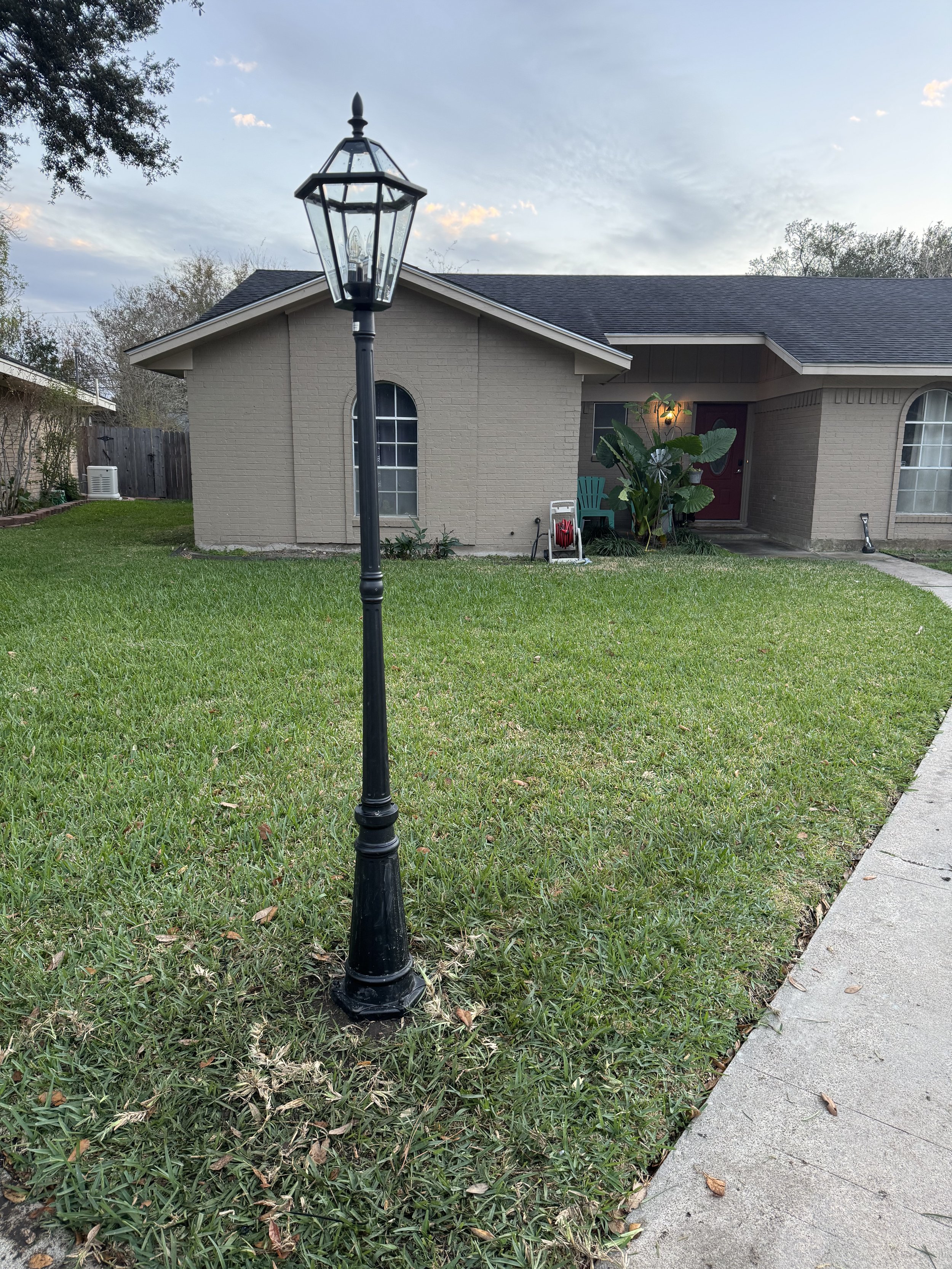 Outdoor lamp post installed to improve pathway lighting and curb appeal.