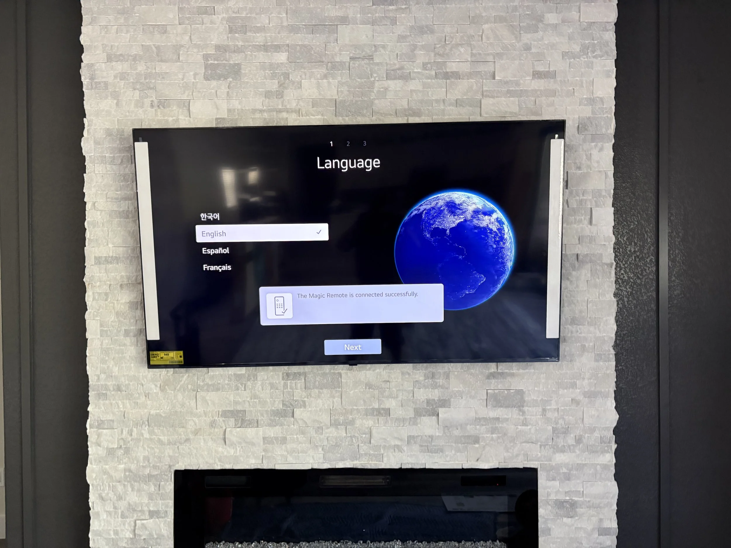 Wall-mounted television installed with clean alignment and professional finish above fireplace.