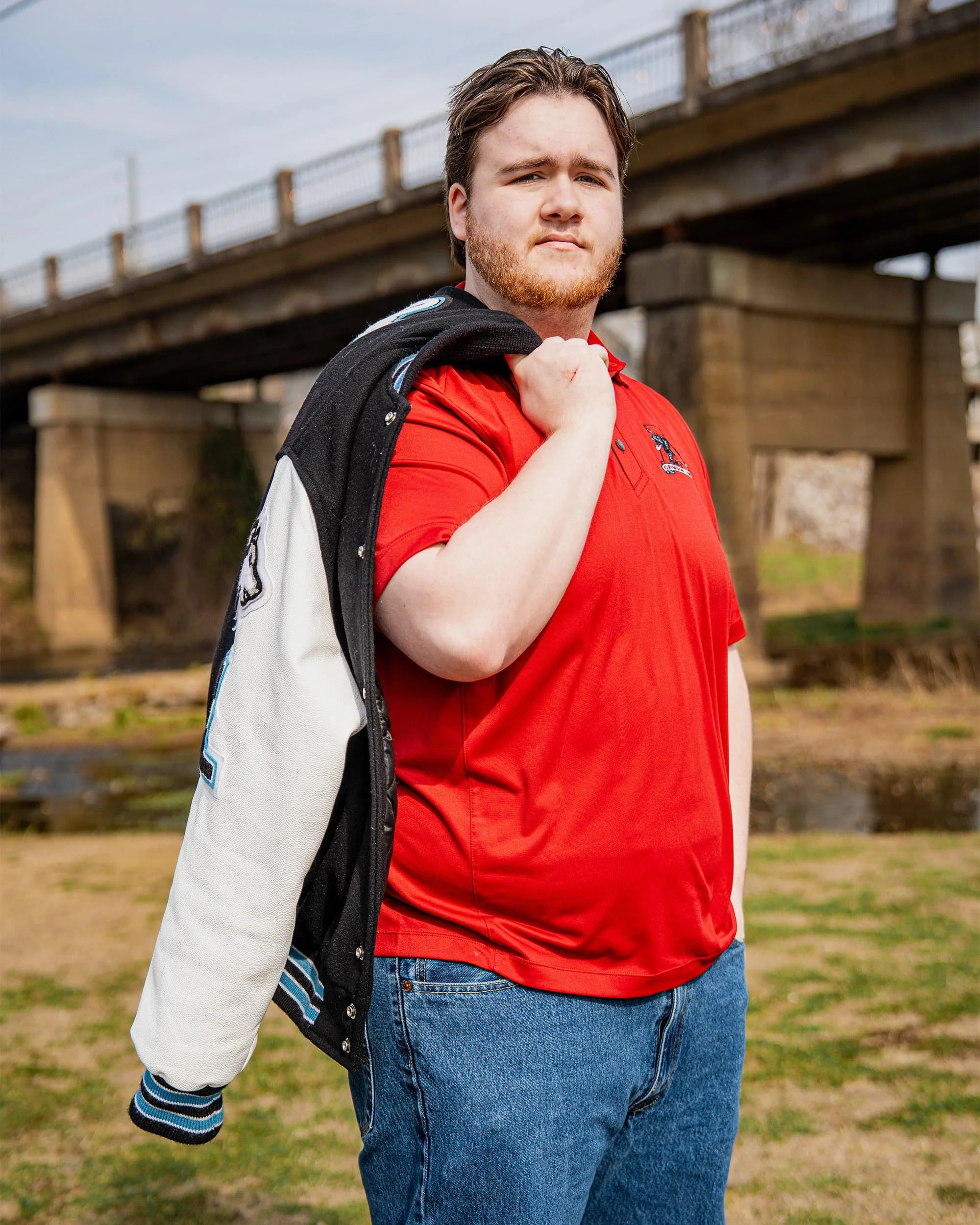 senior portrait of a boy under a bridge
