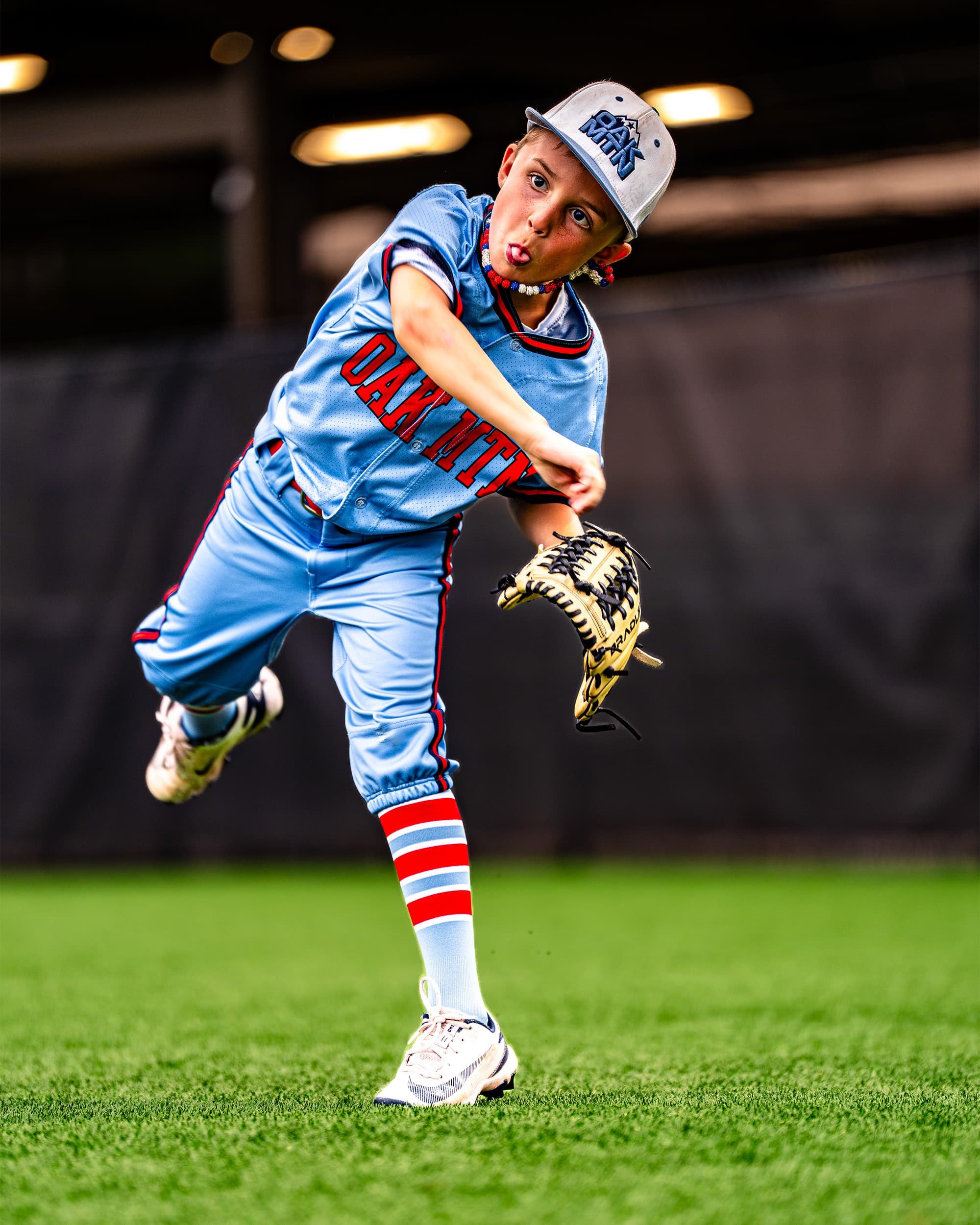 boys baseball player throwing ball in outfield