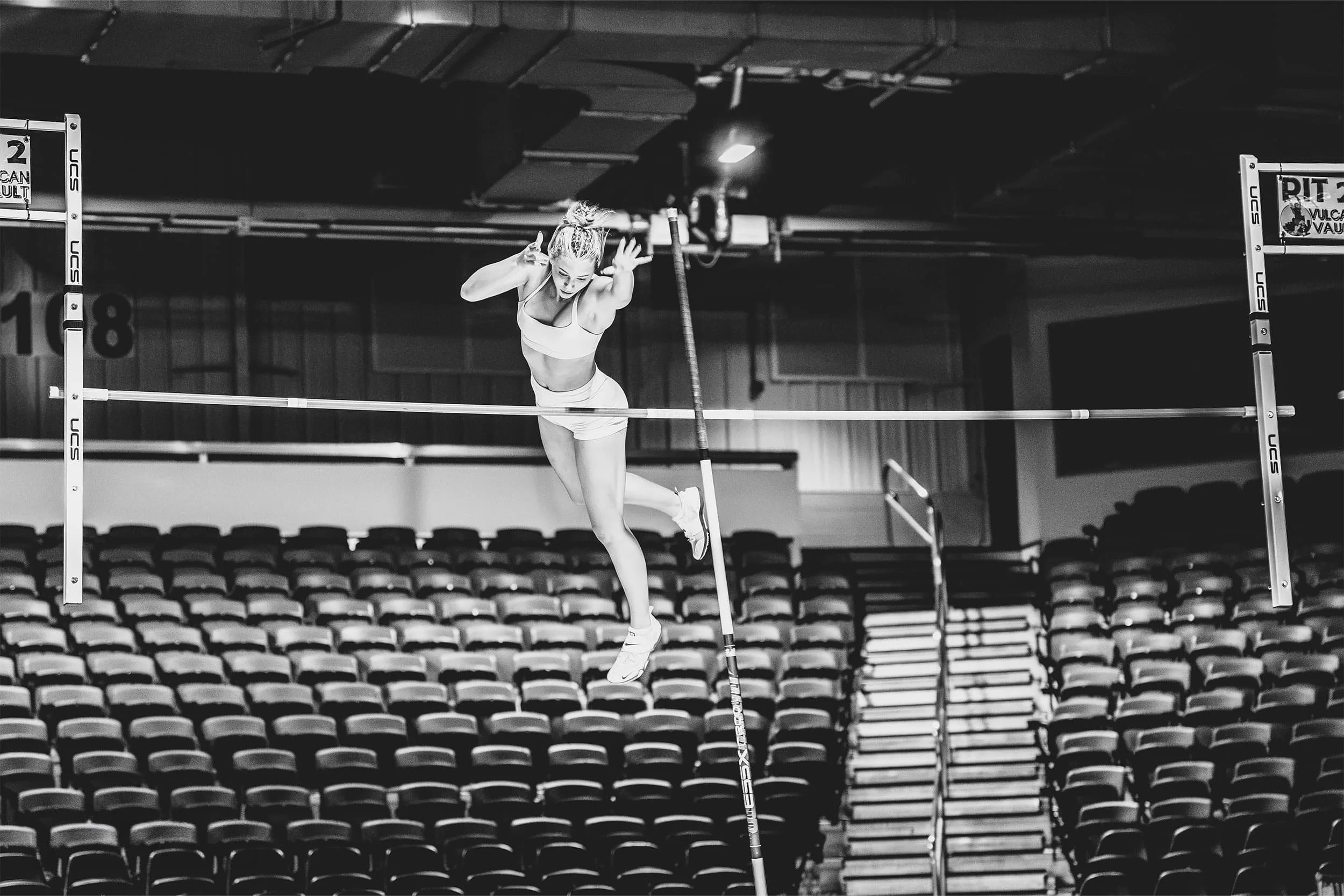 female pole vaulter clearing a jump